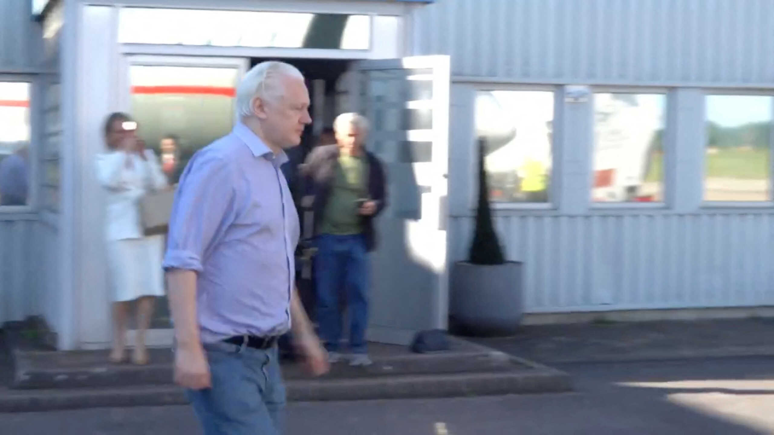 WikiLeaks founder Julian Assange walks to board a plane at a location given as London, Britain, in this still image from video released JUNE 25, 2024.  "@wikileaks" via X