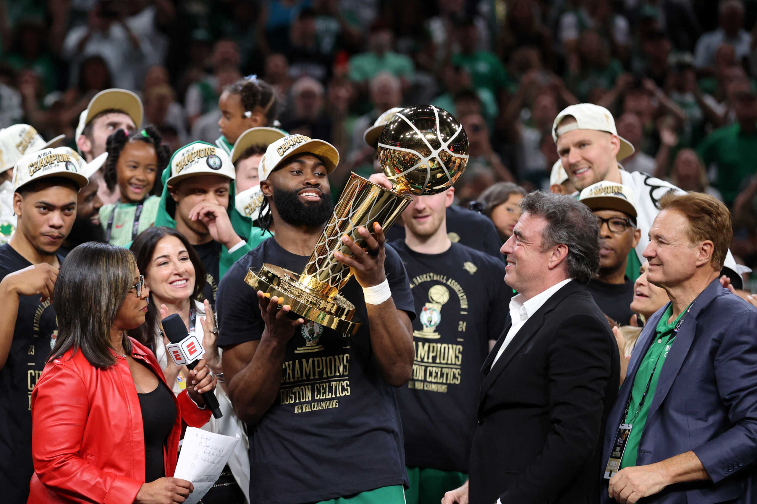 Jun 17, 2024; Boston, Massachusetts, USA; Boston Celtics guard Jaylen Brown (7) holds the trophy after winning the 2024 NBA Finals against the Dallas Mavericks at TD Garden. Mandatory Credit: Peter Casey-USA TODAY Sports