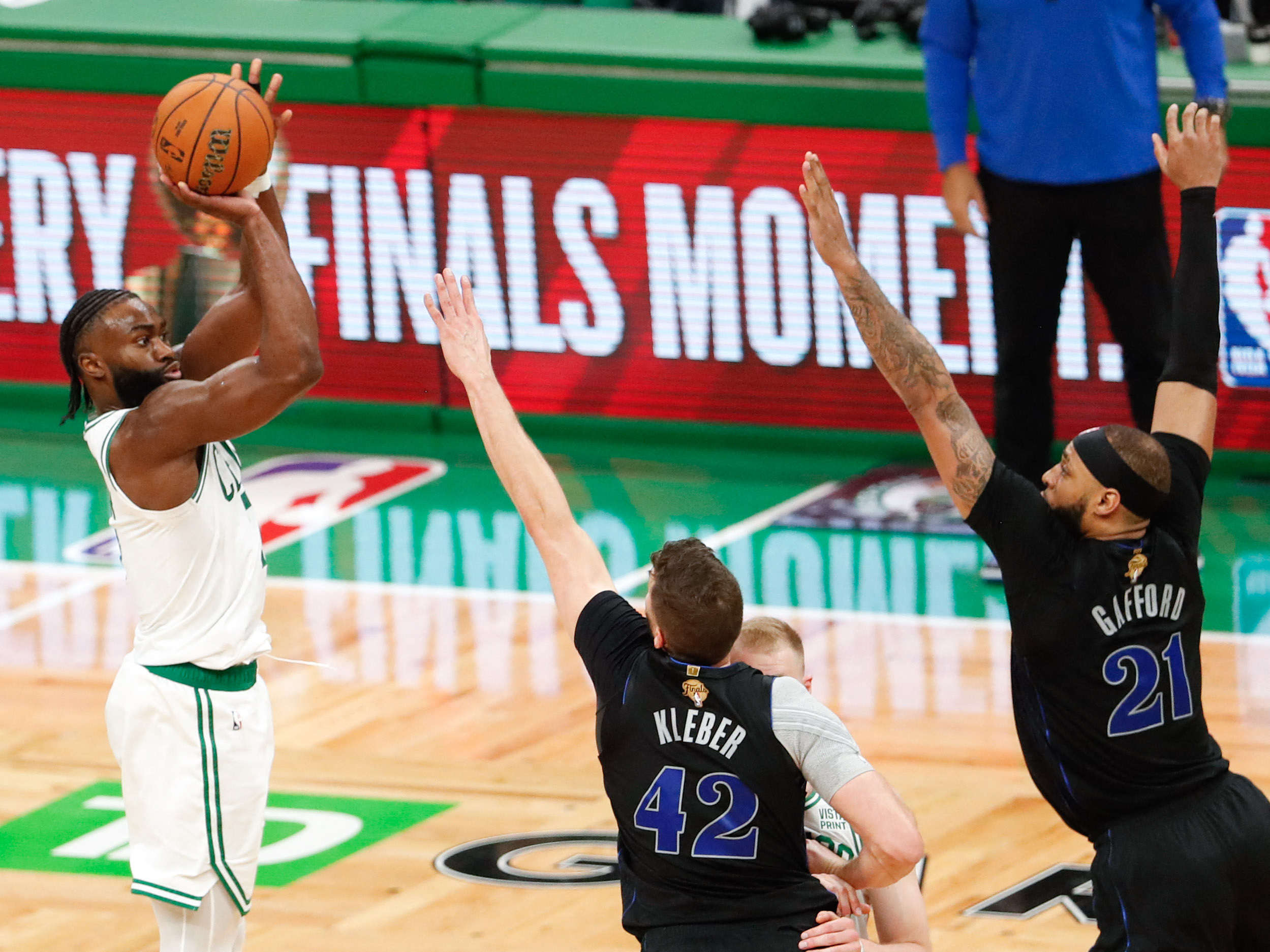 Jun 6, 2024; Boston, Massachusetts, USA; Boston Celtics guard Jaylen Brown (7) attempts a three-point basket against Dallas Mavericks forward Maxi Kleber (42) and center Daniel Gafford (21) during the third quarter of game one of the 2024 NBA Finals at TD Garden. Mandatory Credit: USA TODAY Sports Images