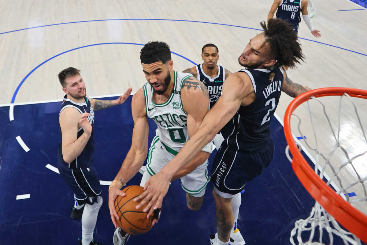 Jun 12, 2024; Dallas, Texas, USA; Boston Celtics forward Jayson Tatum (0) battles for the ball against Dallas Mavericks center Dereck Lively II (2) during the second quarter during game three of the 2024 NBA Finals at American Airlines Center. Mandatory Credit: Stacy Revere