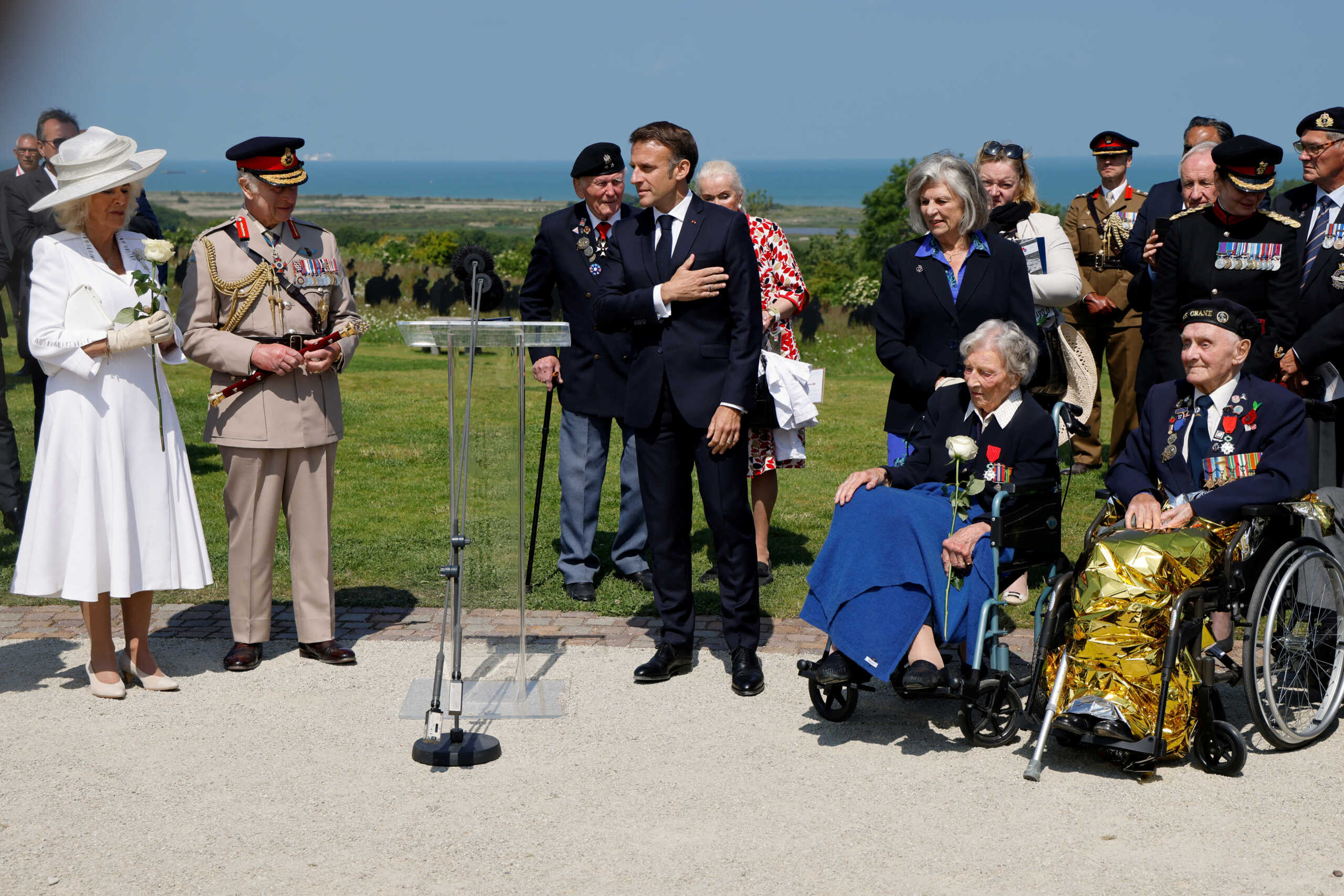 France's President Emmanuel Macron reacts after addressing British D-Day veterans, including 104-years-old British World War II veteran, Christian Lamb, who helped to plan the D-Day landings in Normandy, as Britain's Queen Camilla and Britain's King Charles III look on during the UK Ministry of Defence and the Royal British Legion?s commemorative ceremony marking the 80th anniversary of the World War II "D-Day" Allied landings in Normandy, at the World War II British Normandy Memorial near the village of Ver-sur-Mer which overlooks Gold Beach and Juno Beach in northwestern France, on June 6, 2024.  LUDOVIC MARIN