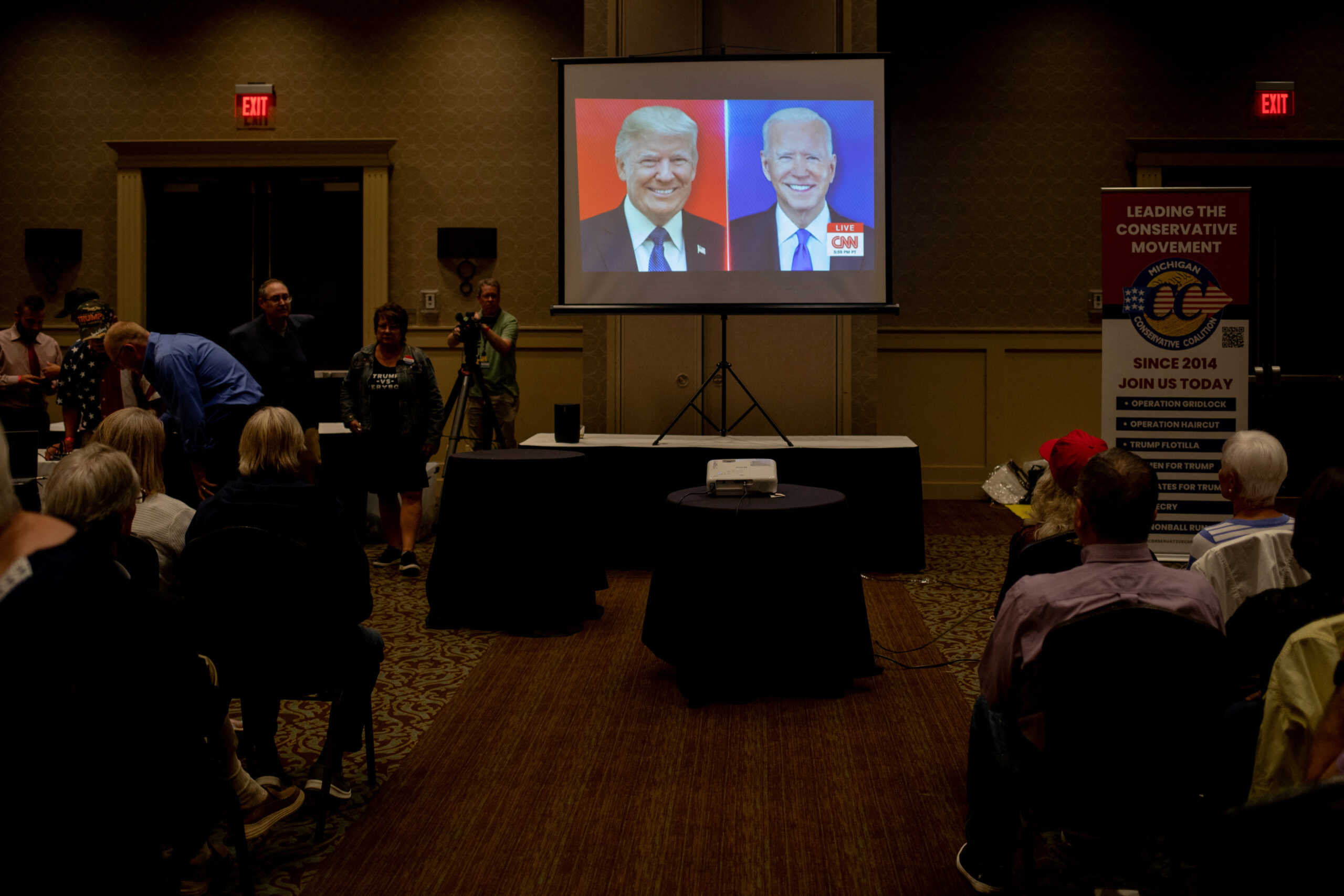 People watch the first presidential debate between U.S. President Joe Biden and former U.S. President and Republican presidential candidate Donald Trump during a watch party hosted by the Michigan Conservative Coalition in Novi, Michigan, U.S., June 27, 2024.     REUTERS