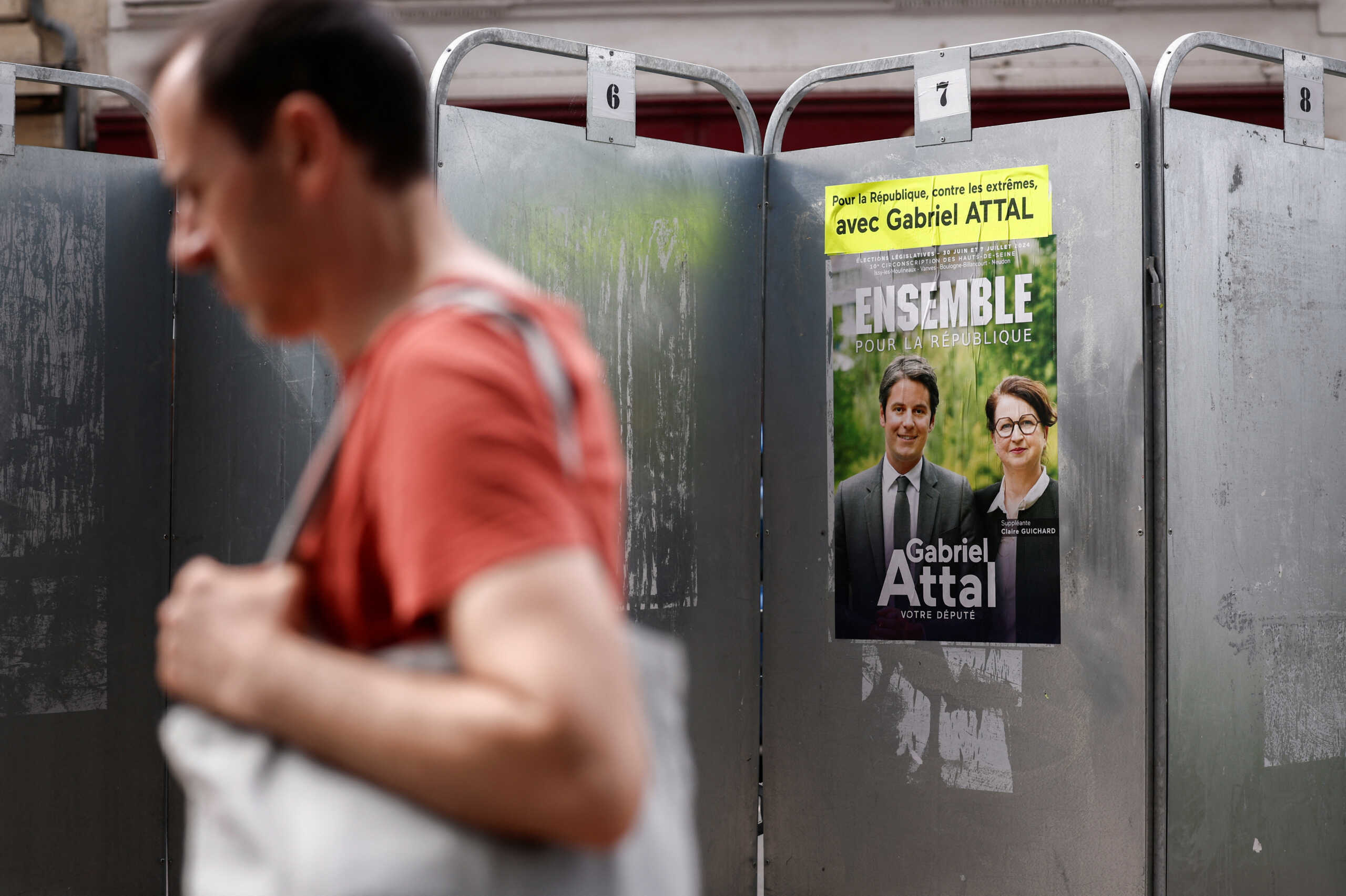 A campaign poster of French Prime Minister Gabriel Attal ("Ensemble pour la Republique") and Claire Guichard on election boards is pictured ahead of the June 30 and July 7 French parliamentary elections, in Issy-les-Moulineaux, France, June 19, 2024. REUTERS