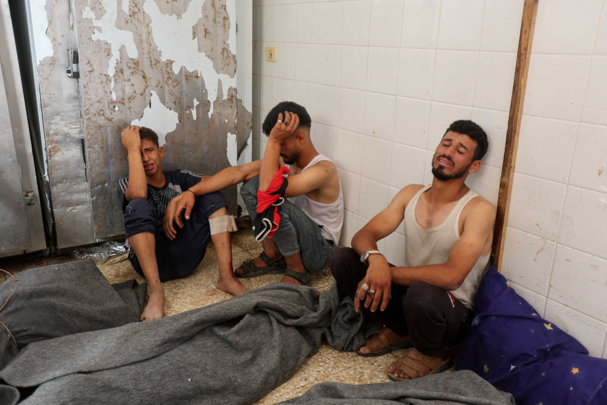 Mourners react during the funeral of Palestinians killed in Israeli strikes, amid the Israel-Hamas conflict, in Deir Al-Balah, in central Gaza Strip June 8, 2024. REUTERS