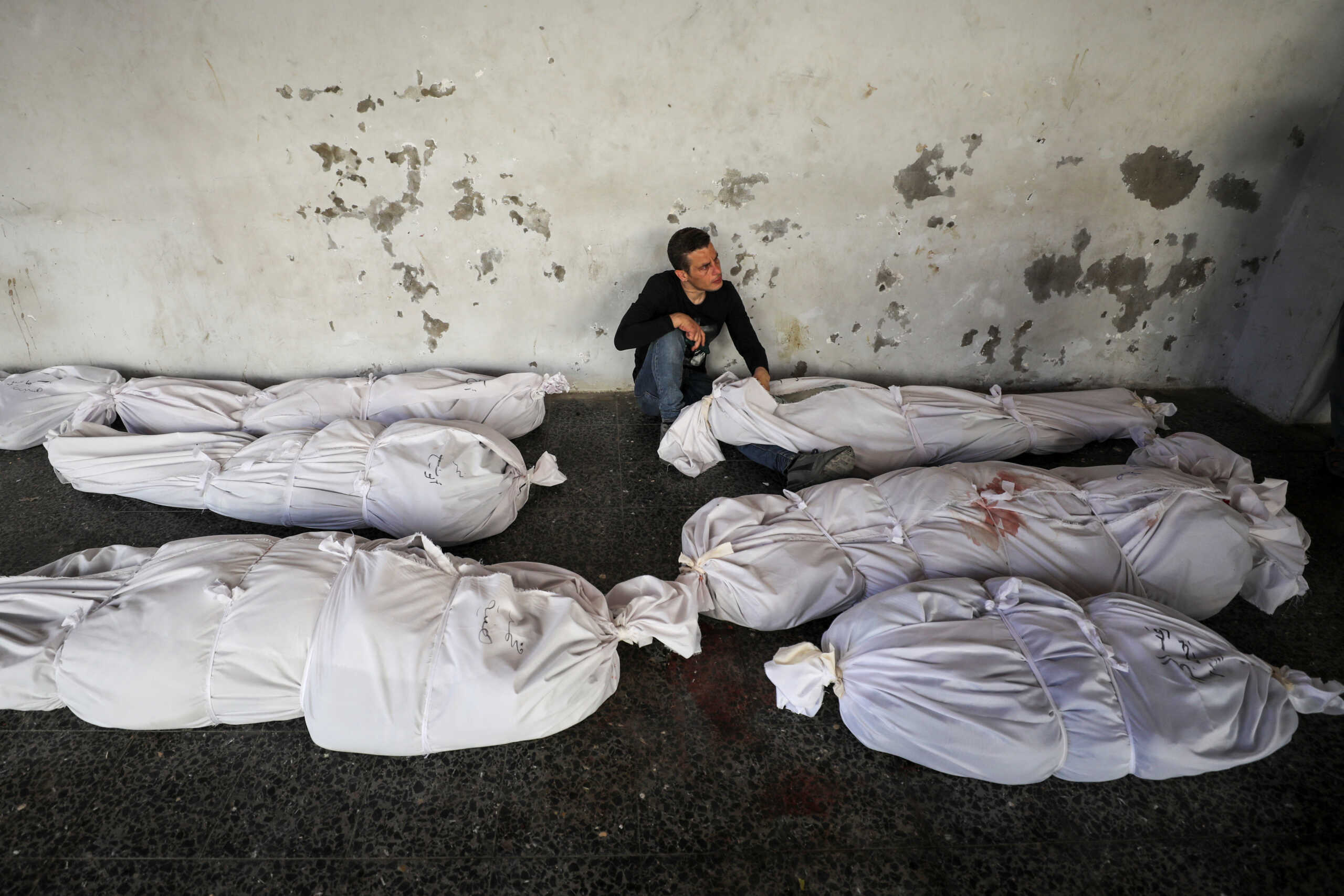 A mourner reacts next to the bodies of Palestinians, including Hamas leader Ismail Haniyeh's relatives, who were killed in an Israeli strike, amid Israel-Hamas conflict, at Al-Ahli al-Arabi hospital in Gaza City, June 25, 2024. REUTERS