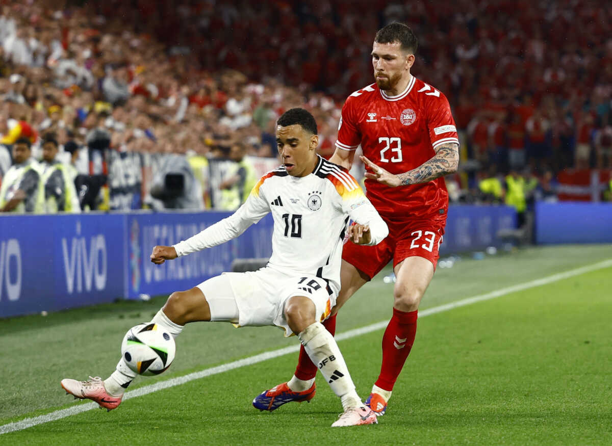 Soccer Football - Euro 2024 - Round of 16 - Germany v Denmark - Dortmund BVB Stadion, Dortmund, Germany - June 29, 2024 Germany's Jamal Musiala in action with Denmark's Pierre-Emile Hojbjerg REUTERS
