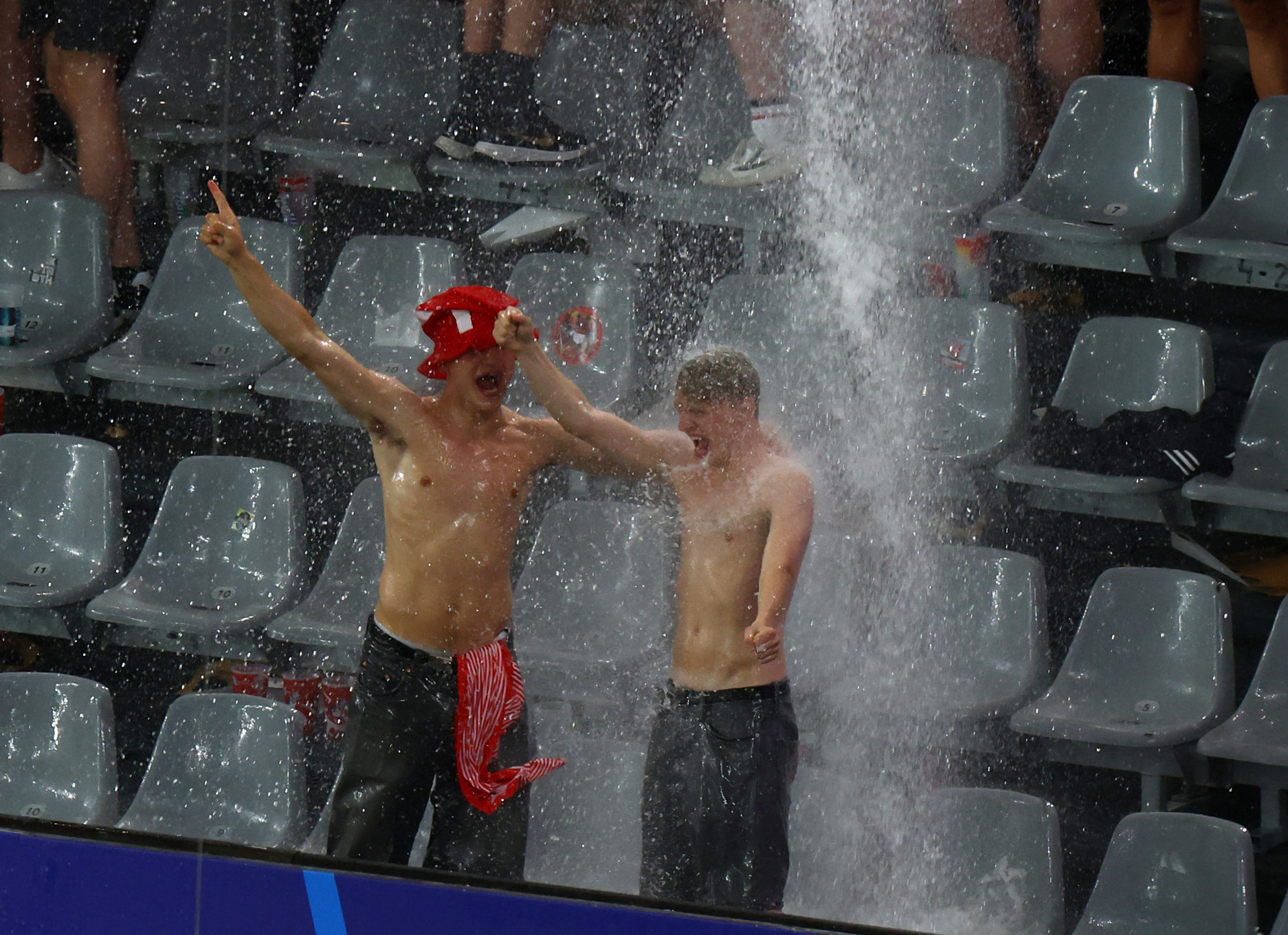 Soccer Football - Euro 2024 - Round of 16 - Germany v Denmark - Dortmund BVB Stadion, Dortmund, Germany - June 29, 2024  Denmark fans are rained on in the stands as the match is stopped due to adverse weather conditions REUTERS