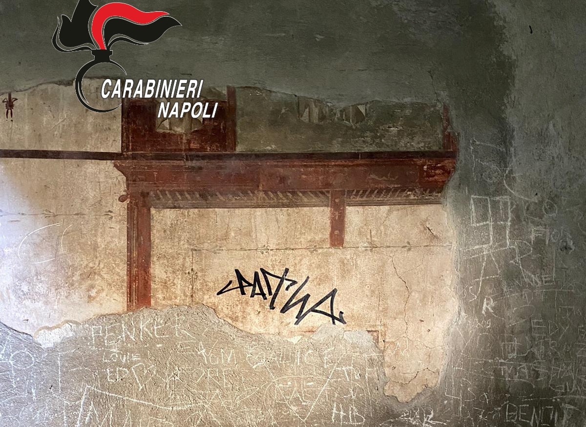A sign made with a black marker by a tourist is pictured on the wall of a domus of the Herculaneum Archaeological Park, in Ercolano, Naples, Italy, in this handout picture obtained on June 3, 2024. Carabinieri