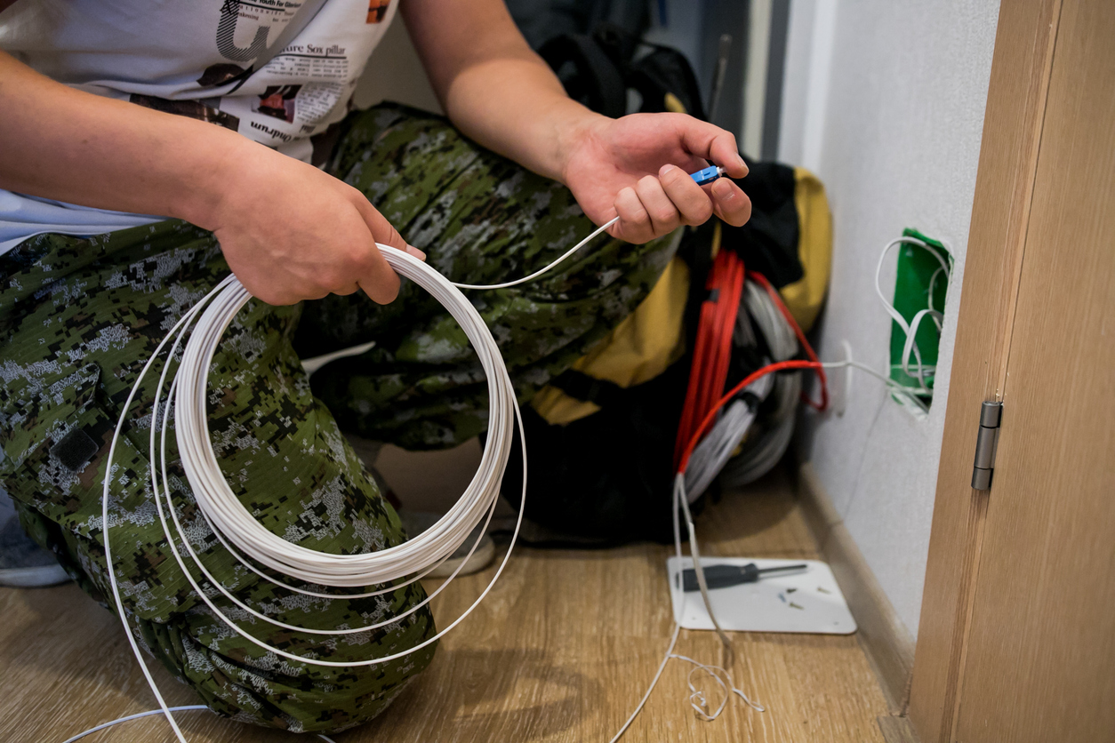 High precision fiber optic cleaver is being used during a fiber optic wire installation at a house