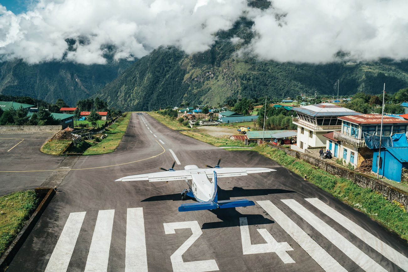Lukla, NEPAL - October 18, 2019: Twin-engine short-range plane landing at the runway of world's most dangerous airport in Lukla,Nepal. TenzingâHillary Airport at altitude 2,845 m