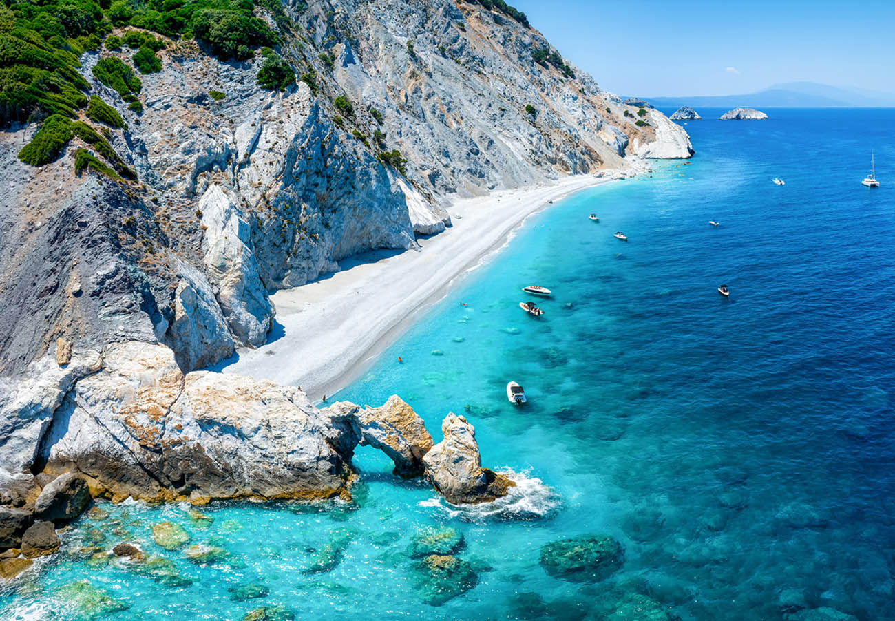 Aerial view of the beautiful Lalaria beach at Skiathos Island, Sporades, Greece, with turquoise shining sea and steep cliffs