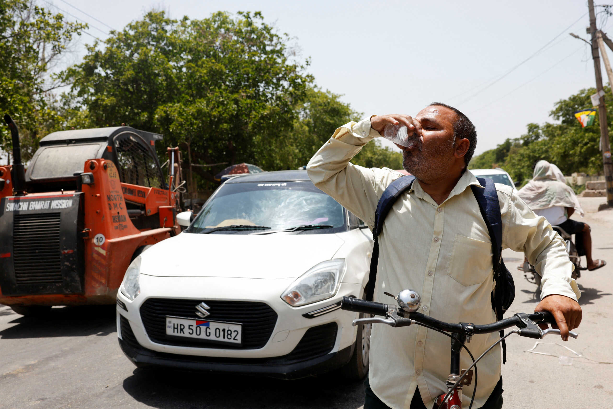 A man drinks a cooling drink offered by locals on a hot summer day during a heatwave in Narela, New Delhi, India, May 29, 2024. REUTERS