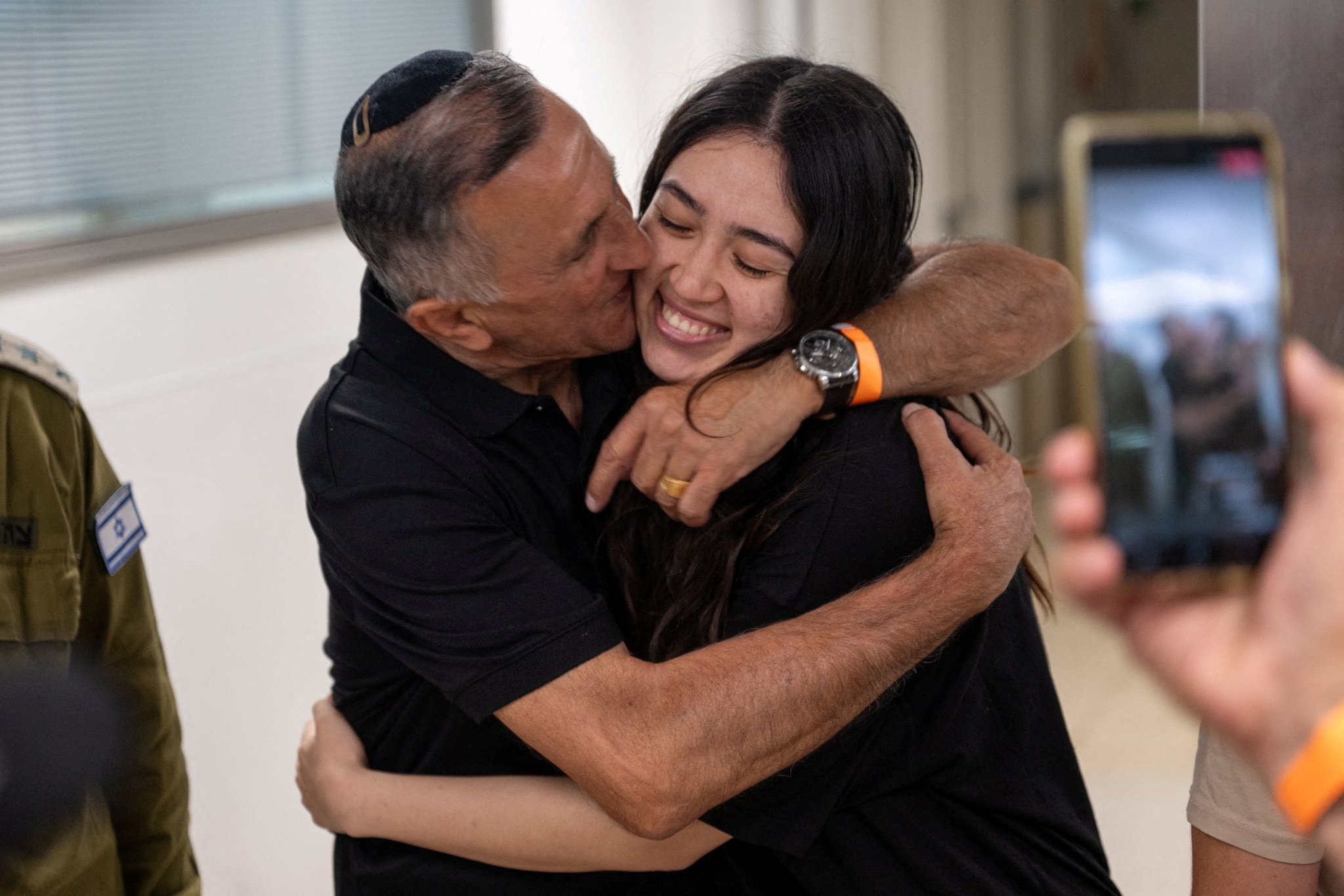 Noa Argamani, a rescued hostage embraces her father, Yakov Argamani, after the military said that Israeli forces have rescued four hostages alive from the central Gaza Strip, in Ramat Gan, Israel, in this handout image obtained by Reuters on June 8, 2024. Israeli Army