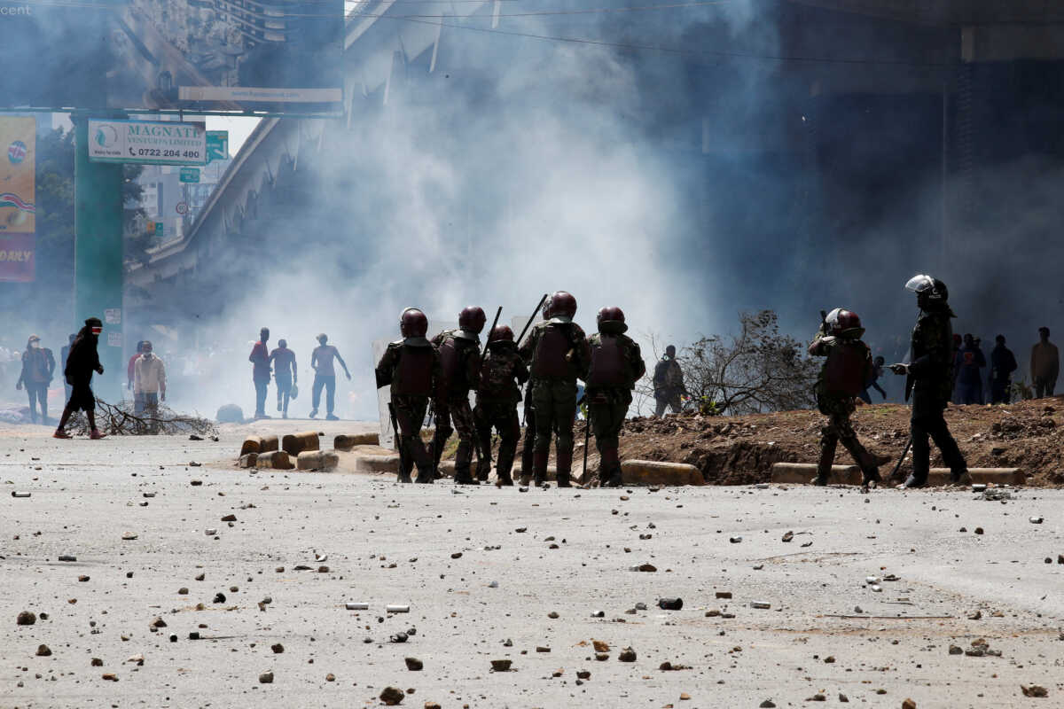 Police stand during a demonstration against Kenya's proposed finance bill 2024