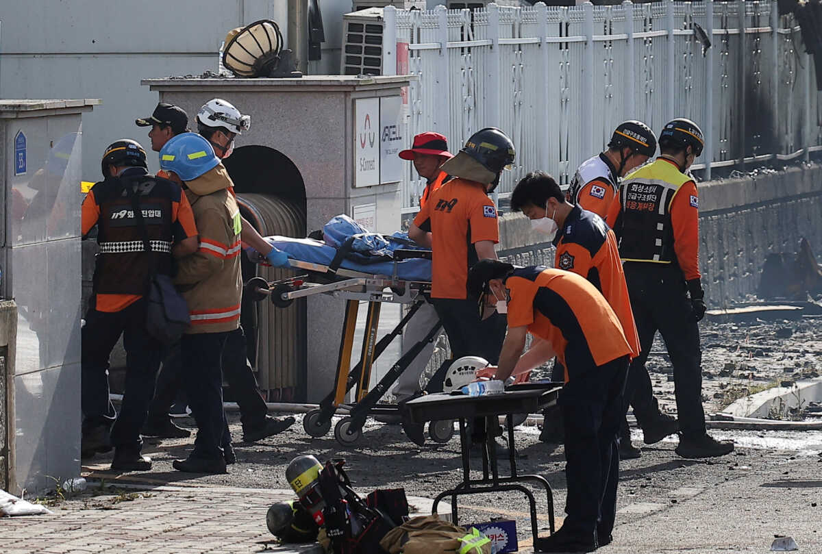 Emergency personnel carry the body of a person killed in a deadly fire at a lithium battery factory owned by South Korean battery maker Aricell, in Hwaseong, South Korea, June 24, 2024. REUTERS