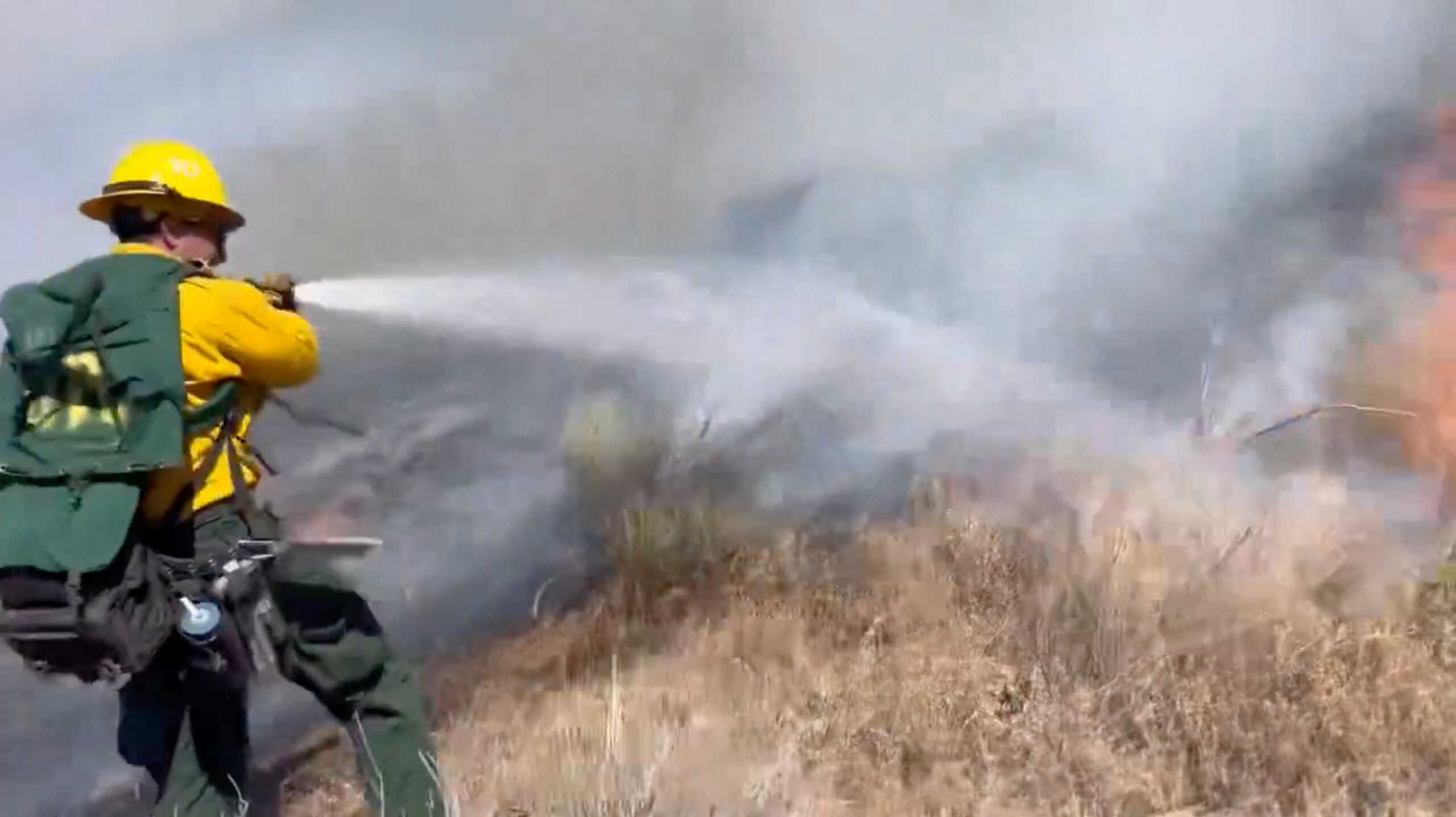 A firefighter works to contain the fire at Pyramid Lake, California, U.S., June 16, 2024, in this picture obtained from social media video. @Angeles_NF