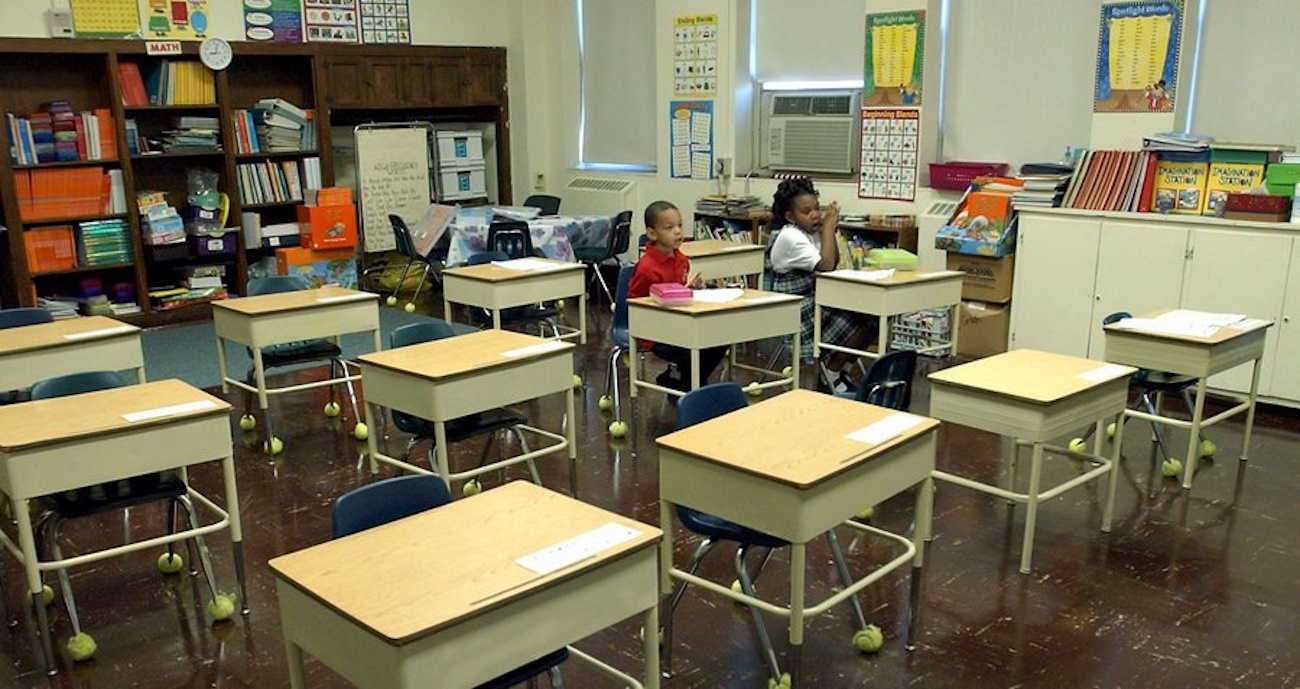 epa00554985 Only two students made up the First Grade Class on the opening day of school at Cathedral Academy in New Orleans, Louisiana's French Quarter, Monday 17 October 2005. The day started with 12 original students, but throughout the morning, dozens more parents had arrived to enroll their children and the phones were ringing off the hook as a lone secretary struggled to keep up.  EPA