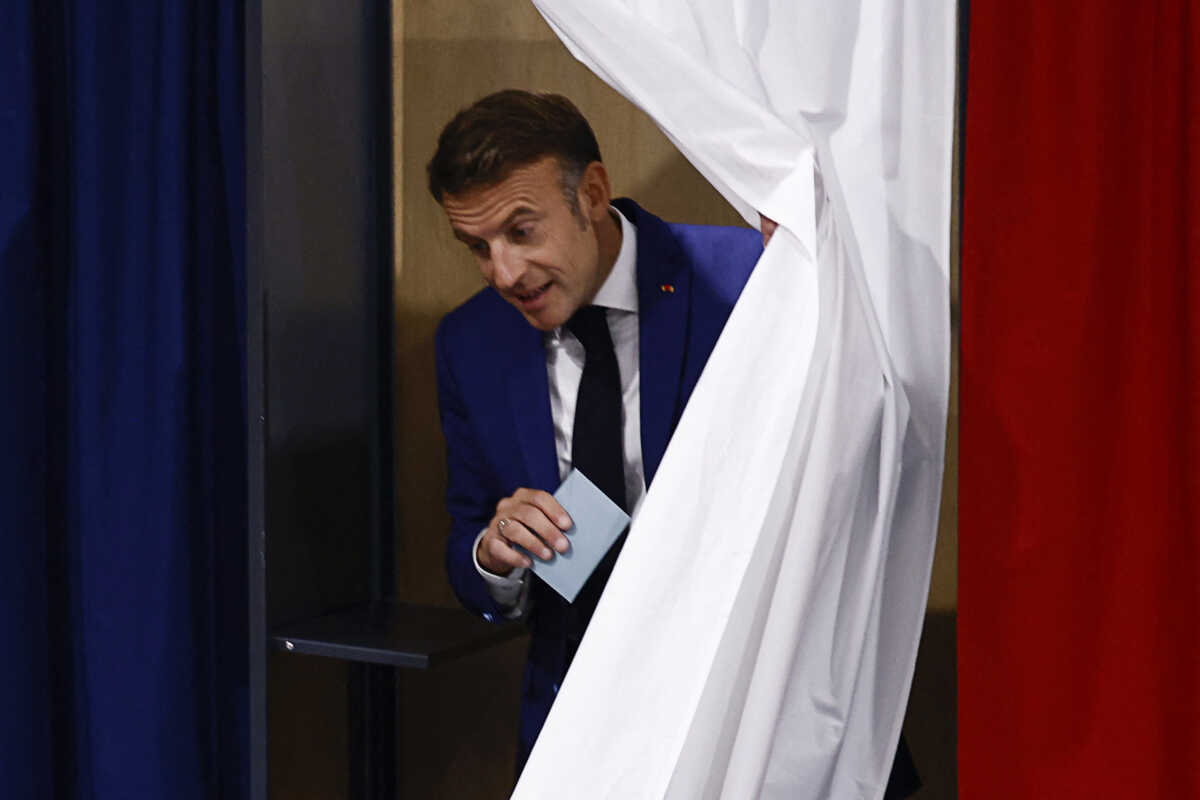 French President Emmanuel Macron leaves a voting booth, as he visits a polling station to vote in the first round of the early French parliamentary elections, in Le Touquet-Paris-Plage, France, June 30, 2024. REUTERS