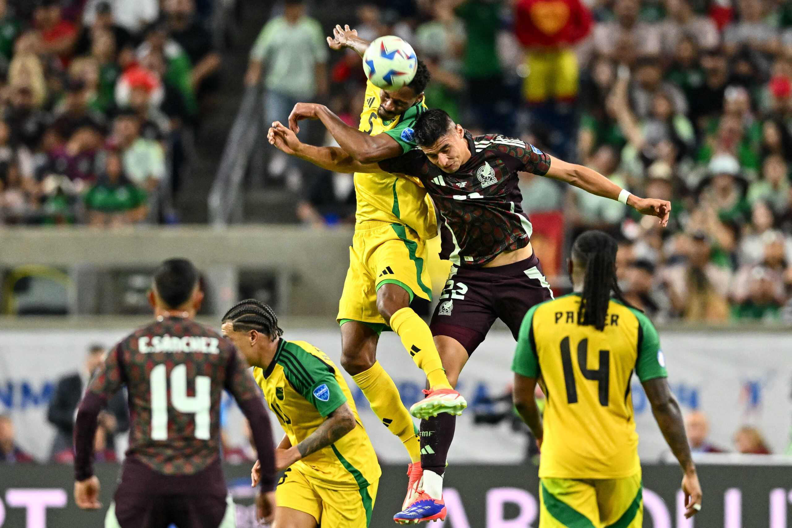 Jun 22, 2024; Houston, TX, USA; Jamaica defender Ethan Pinnock (5) and Mexico forward Guillermo Martinez (22) goes up for a header during the second half at NRG Stadium. Mandatory Credit: Maria Lysaker-USA TODAY Sports