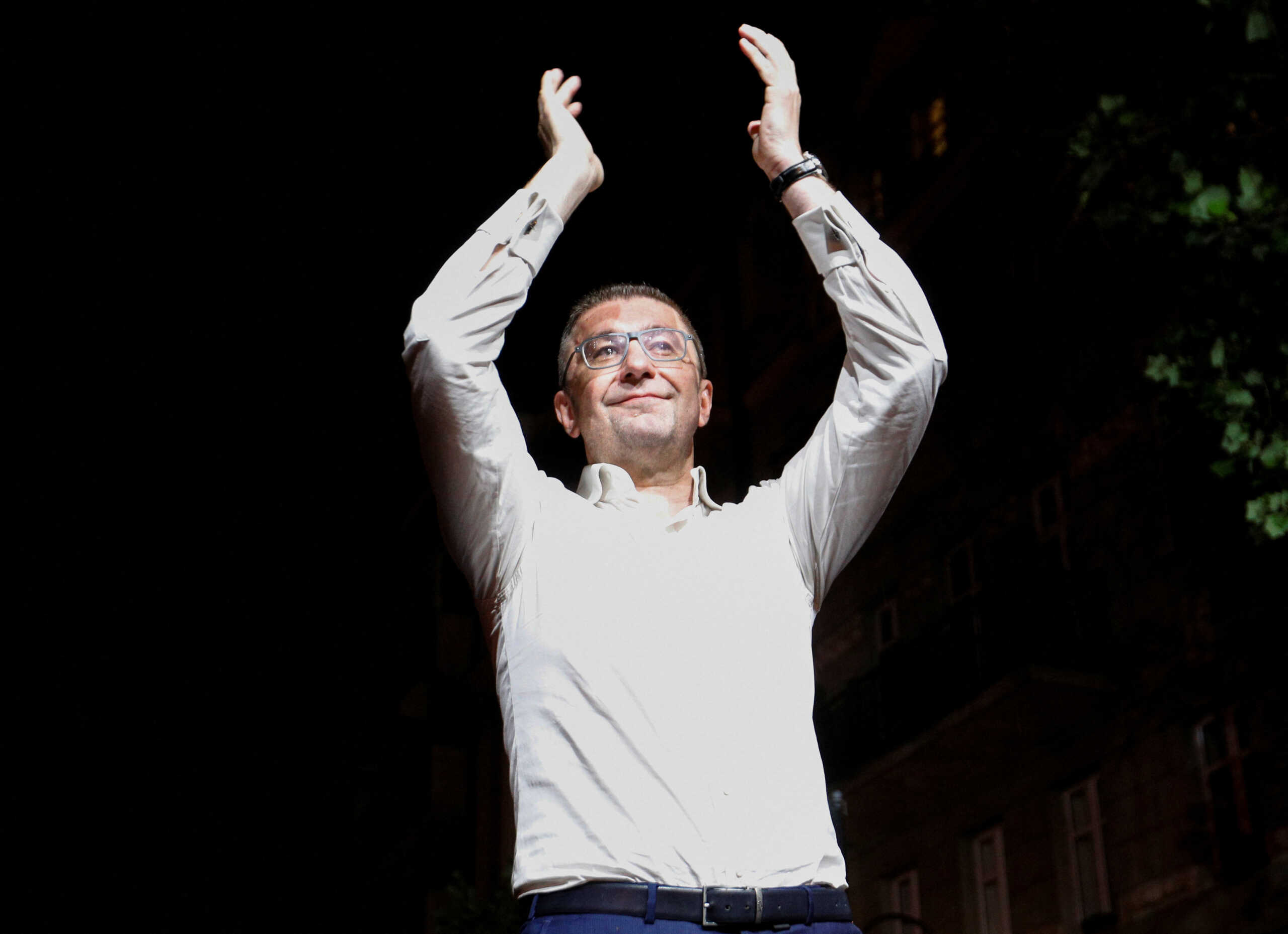 North Macedonian opposition party VMRO-DPMNE leader Hristijan Mickoski applauds as he addresses supporters following the parliamentary elections and second round of the presidential election in Skopje, North Macedonia, May 8, 2024. REUTERS