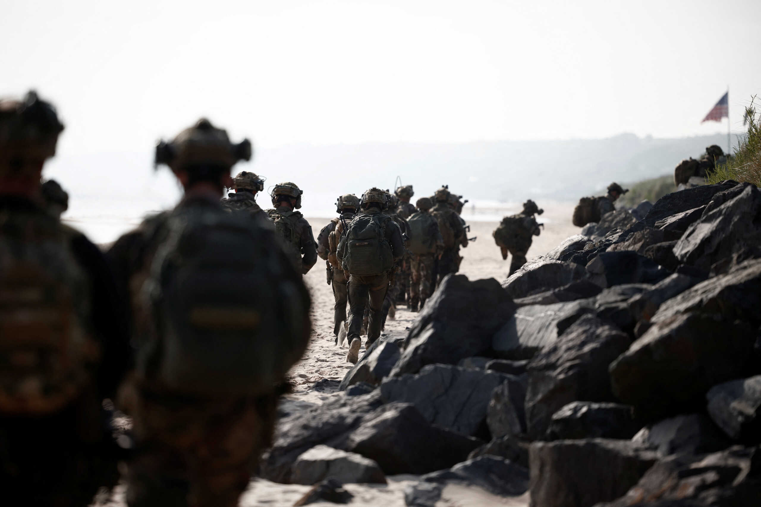 French troops walk during a joint U.S. and French amphibious landing operation showcase at Omaha Beach, ahead of the 80th anniversary of the 1944 D-Day landings in Saint-Laurent-sur-Mer, Normandy region, France, June 4, 2024. REUTERS