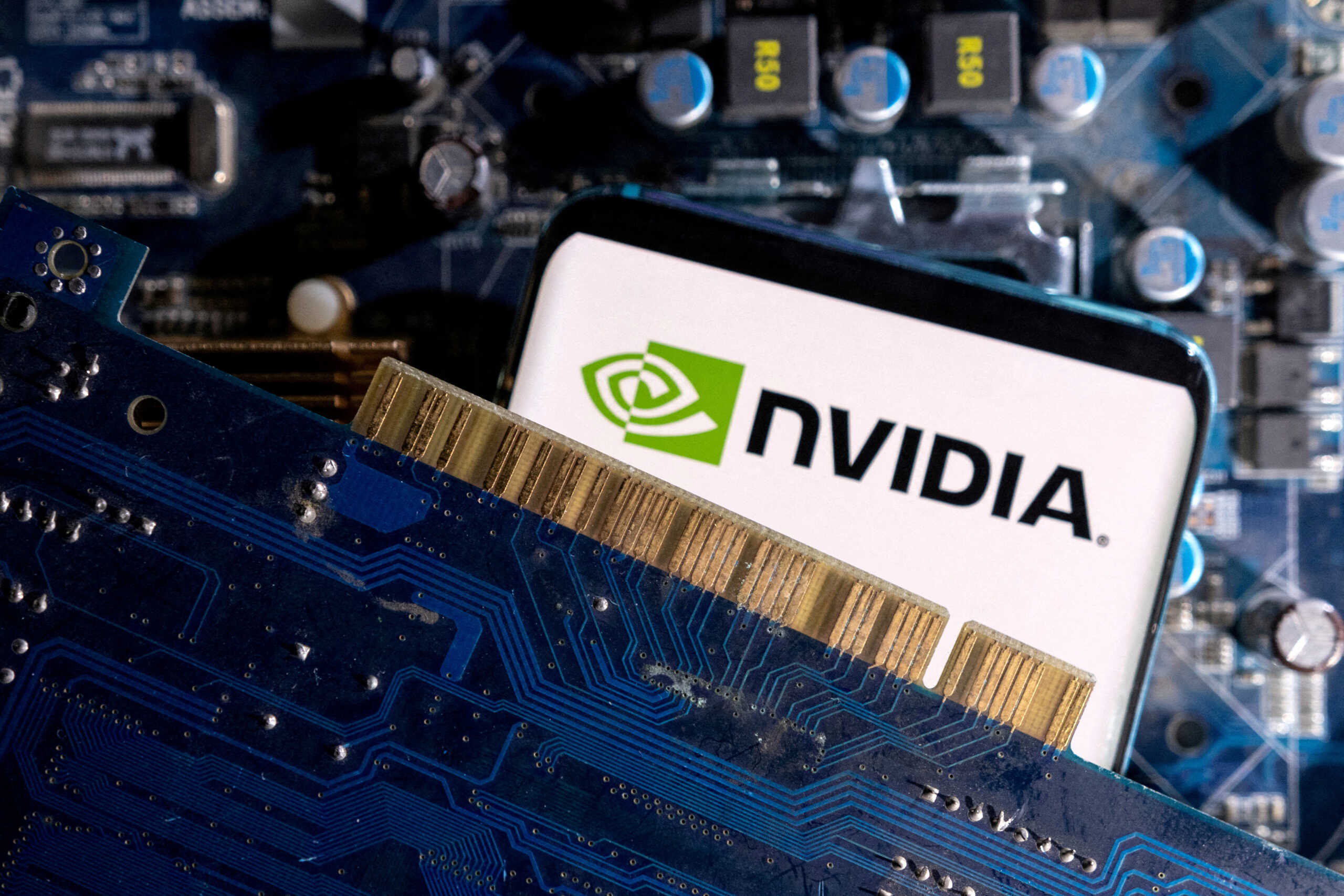FILE PHOTO: A smartphone with a displayed NVIDIA logo is placed on a computer motherboard in this illustration taken March 6, 2023. REUTERS