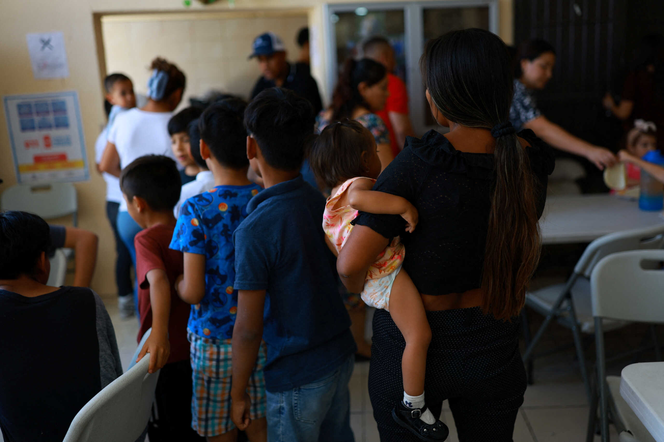 Gianella, a migrant from Peru who, together with her family, is waiting for an appointment on the CBP One application to arrive in the United States after U.S. President Joe Biden announced a sweeping border security enforcement effort, lines up to receive foodinside the Buen Samaritano shelter in Ciudad Juarez, Mexico, June 16, 2024. REUTERS