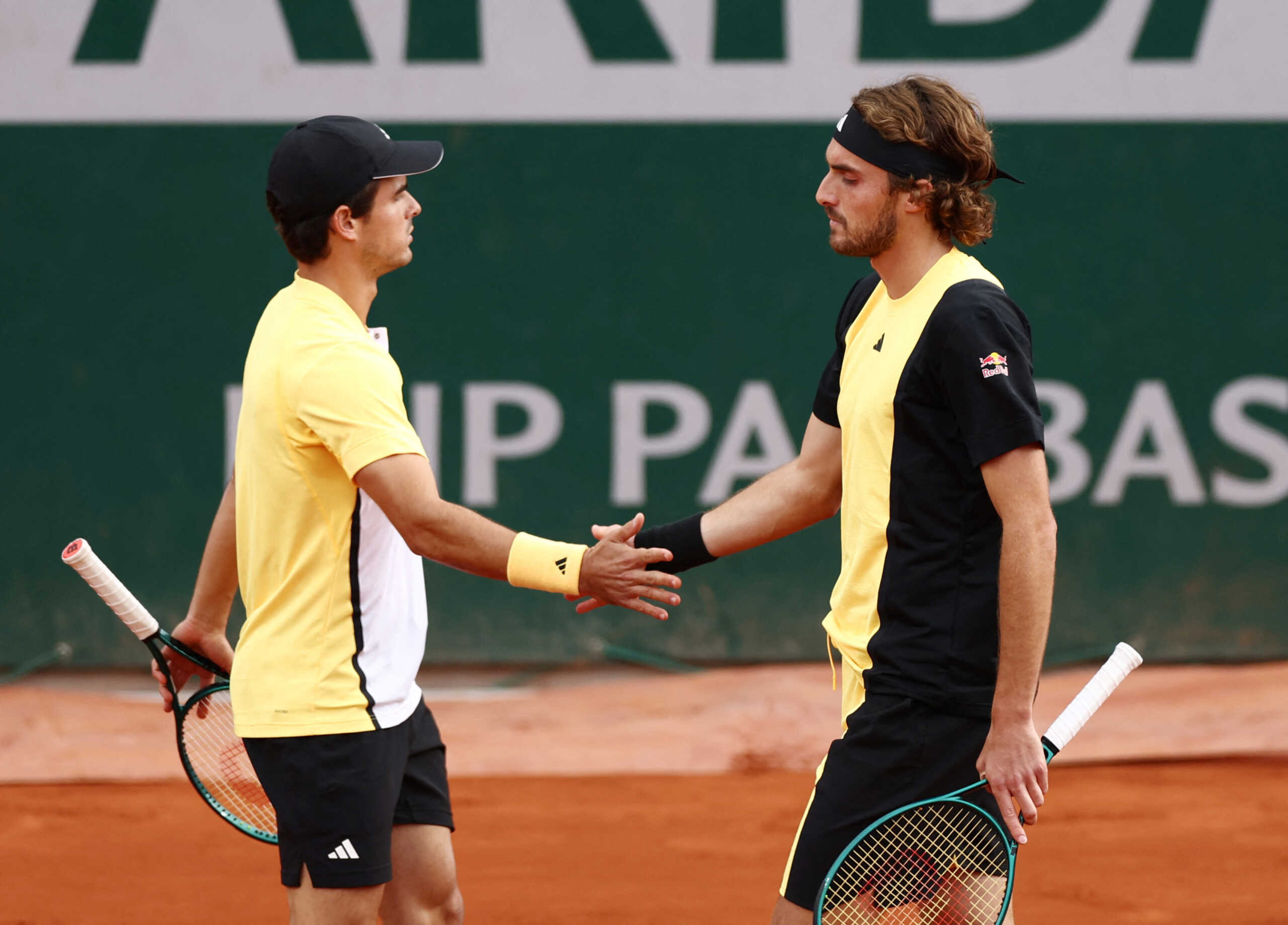 Tennis - French Open - Roland Garros, Paris, France - June 2, 2024 Greece's Petros and Stefanos Tsitsipas shake hands before their men's doubles first round match against Ukraine's Denys Molchanov and Australia's John Patrick Smith REUTERS