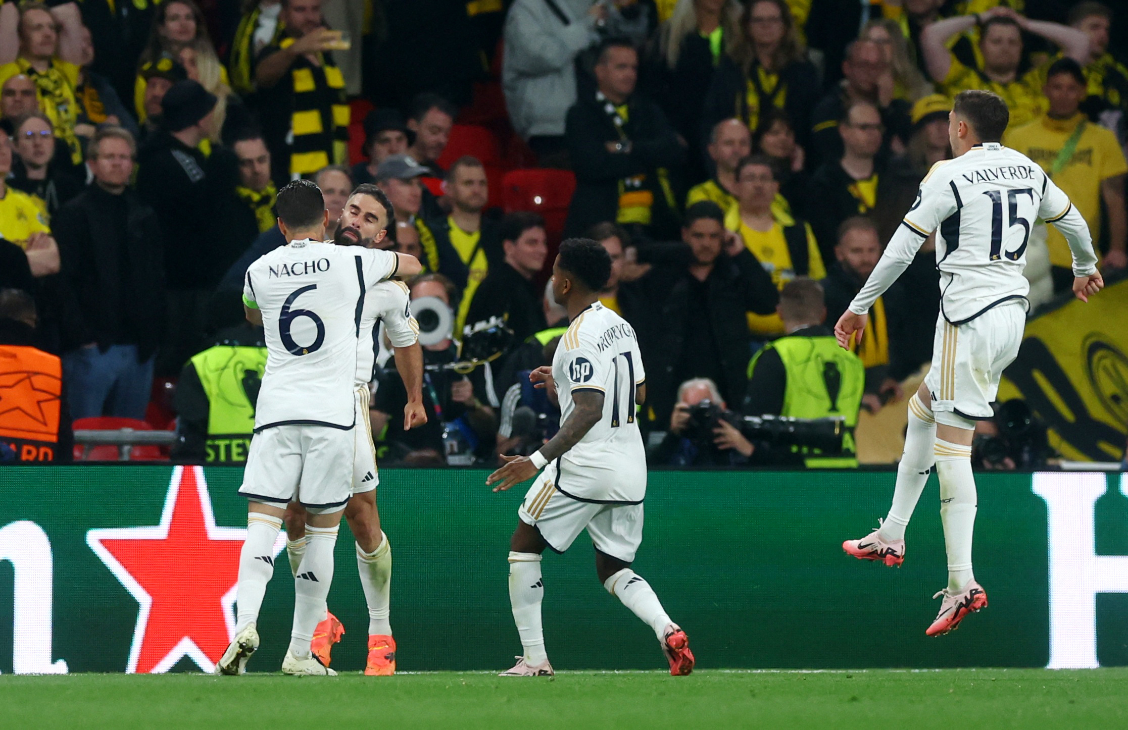 Soccer Football - Champions League - Final - Borussia Dortmund v Real Madrid - Wembley Stadium, London, Britain - June 1, 2024 Real Madrid's Dani Carvajal celebrates scoring their first goal with Nacho and Rodrygo REUTERS
