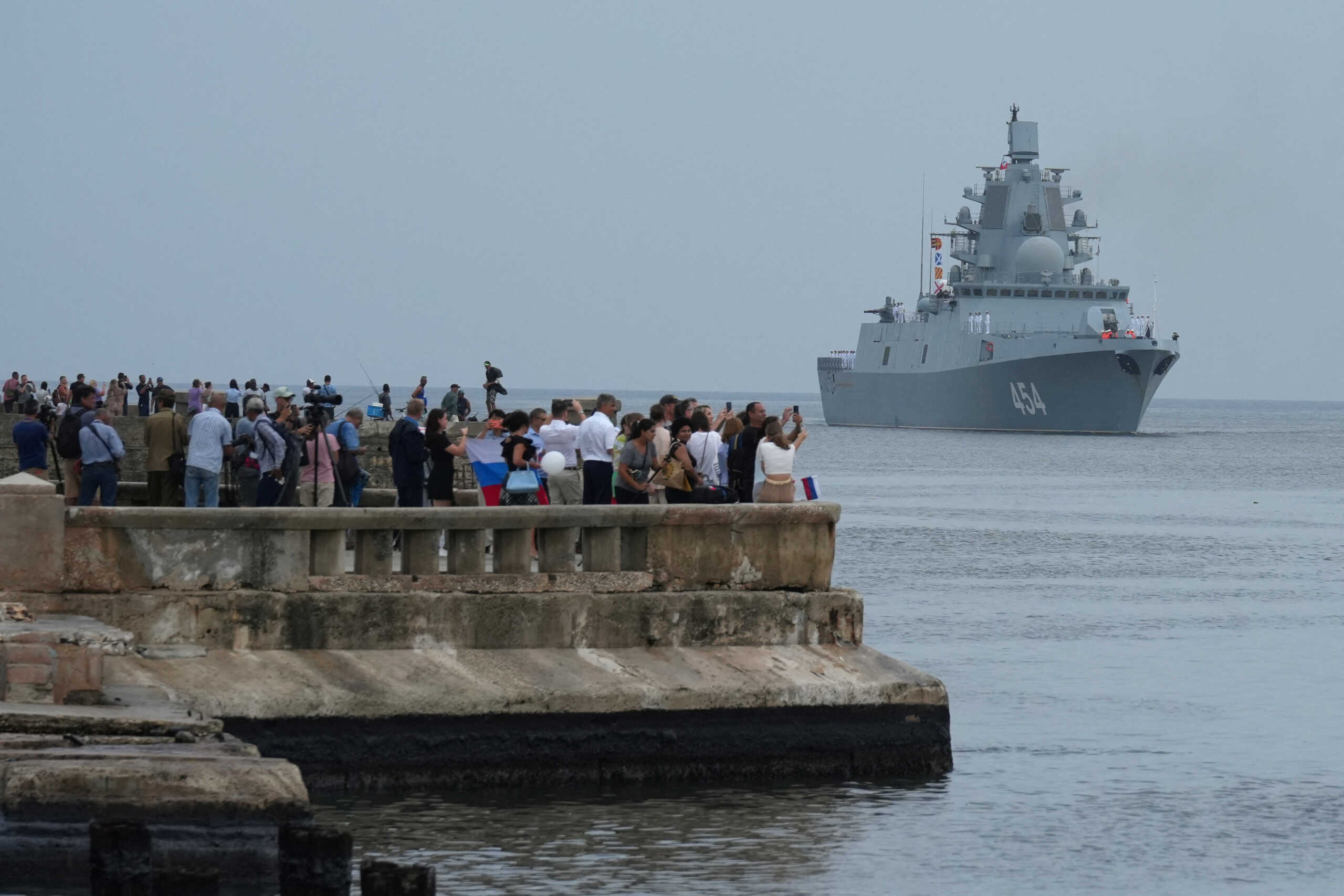 People watch Russian frigate Admiral Gorshkov as it enters Havana’s bay, Cuba, June 12, 2024. REUTERS