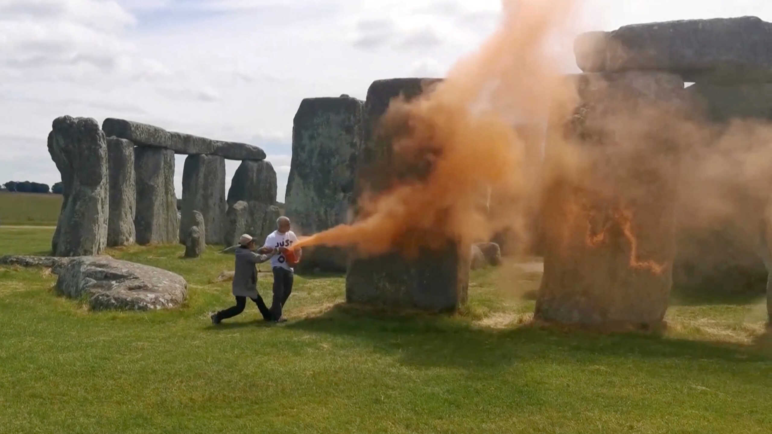 Environmental protesters spray Stonehenge with orange powder paint, in Wiltshire, Britain, June 19, 2024, in this screengrab taken from a video. Just Stop Oil