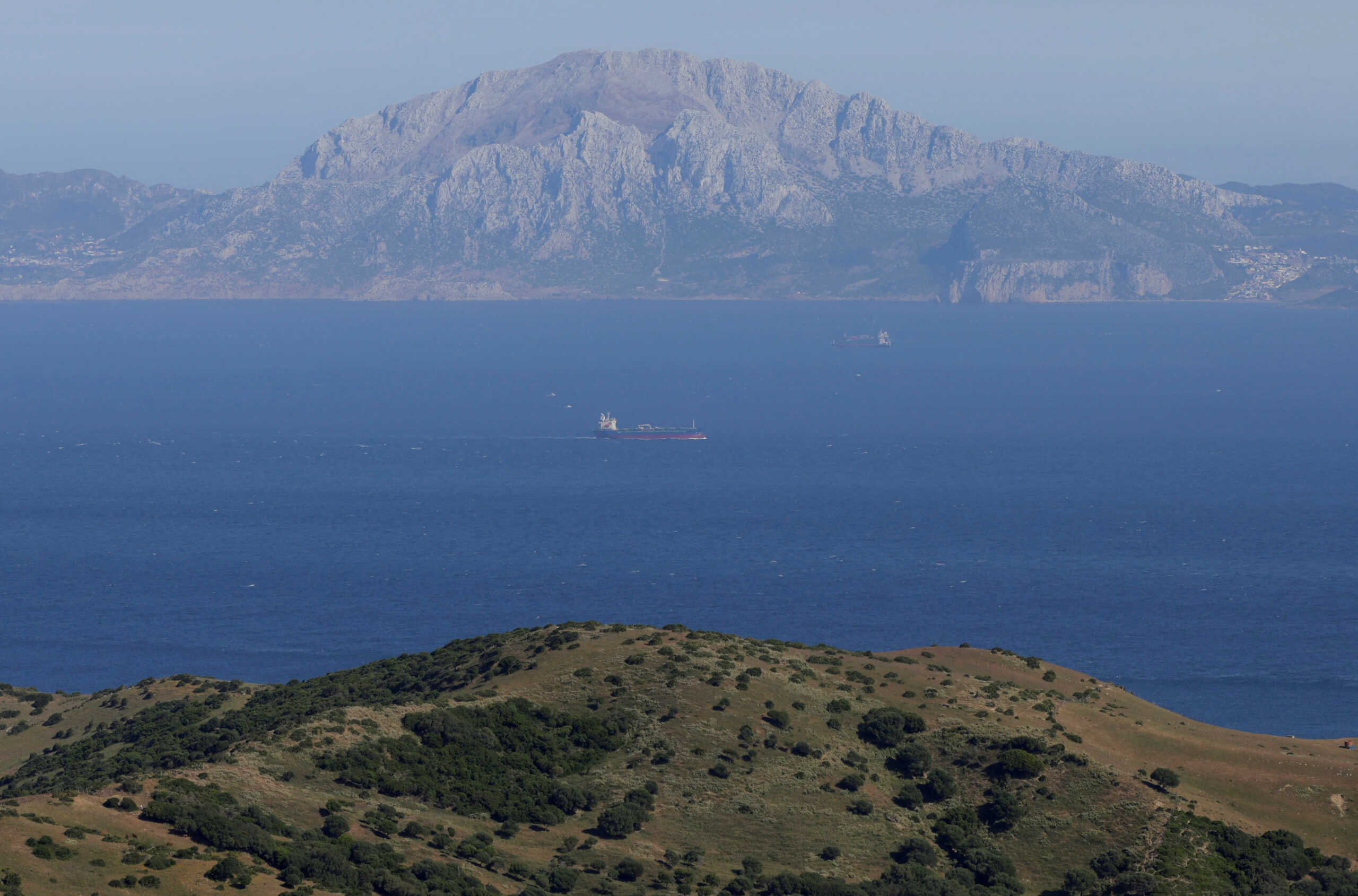A view of cargo and tankers ships sailing in the Strait of Gibraltar, located between the Musa mountain of Morocco and the coast of Spain, pictured from a tourist lookout in Tarifa, southern Spain, June 4, 2024. REUTERS