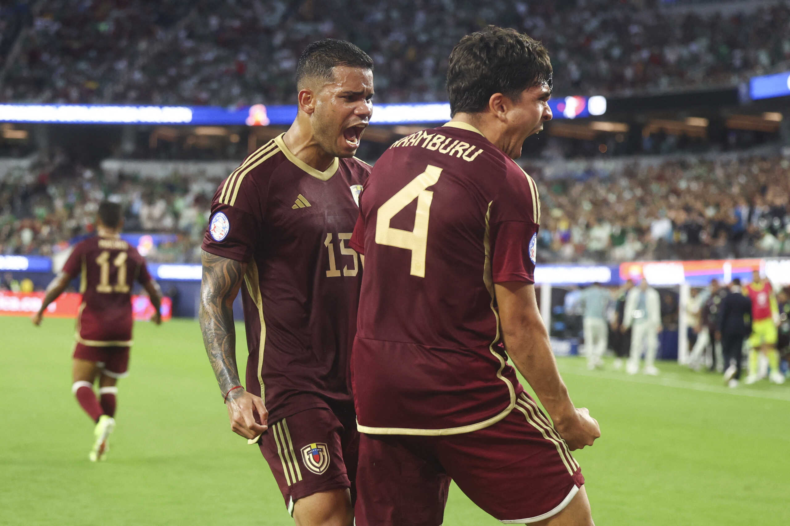 Jun 26, 2024; Inglewood, CA, USA; Venezuela defender Miguel Ángel Navarro (15) and defender Jon Mikel Aramburu (4) react after blocking a cross from Mexico forward Ernesto Vega (10) during the second half a match at SoFi Stadium. Mandatory Credit: Jessica Alcheh-USA TODAY Sports