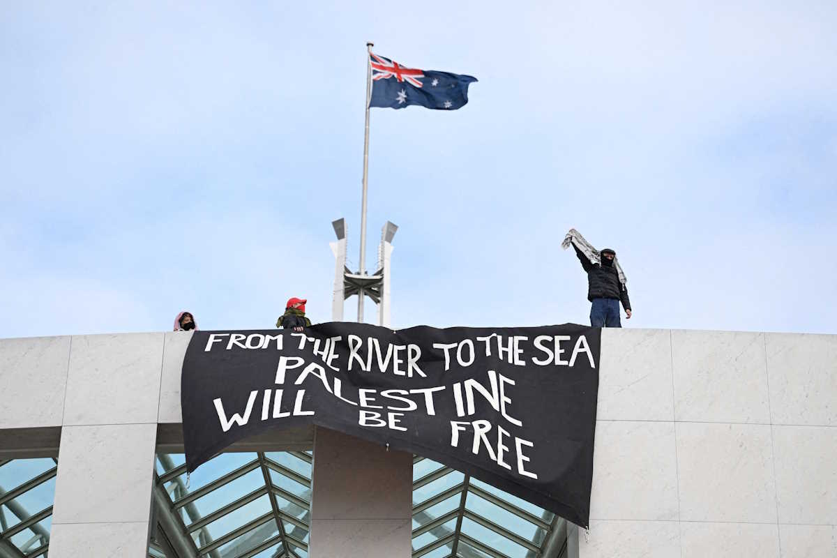Pro-Palestinian protesters hang banners from the top of Parliament House in Canberra, Australia, July 4, 2024. AAP