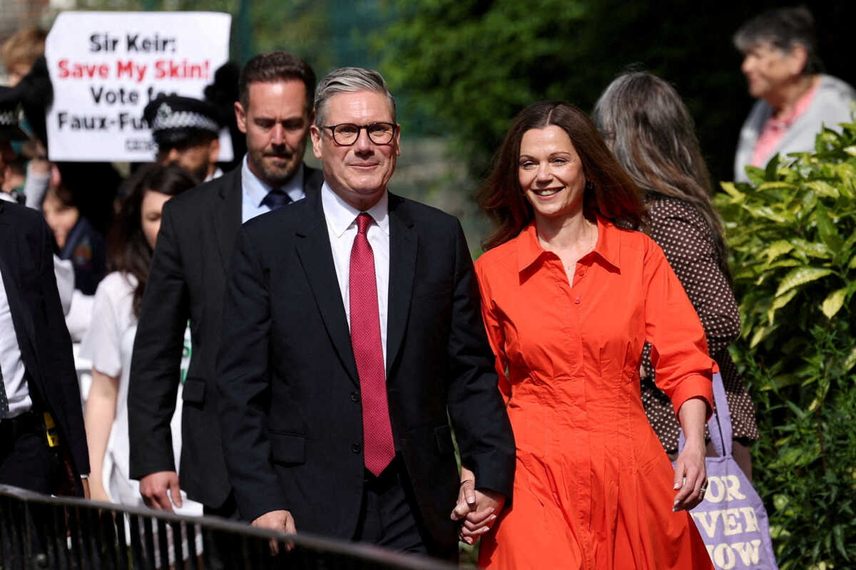 Britain's opposition Labour Party leader Keir Starmer and his wife Victoria Starmer walk outside a polling station during the general election in London, Britain, July 4, 2024. REUTERS