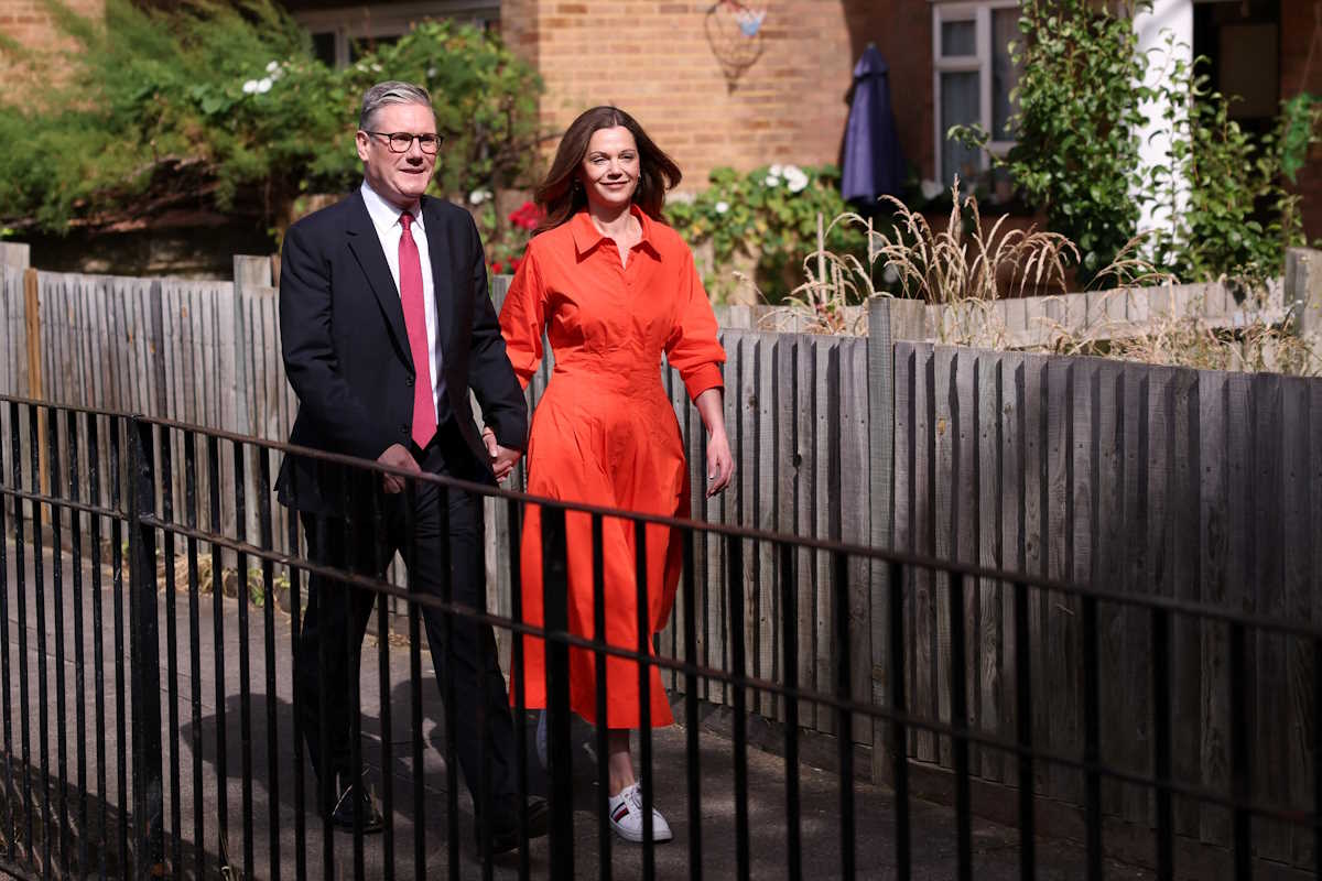Britain's opposition Labour Party leader Keir Starmer and his wife Victoria Starmer walk outside a polling station during the general election in London, Britain, July 4, 2024. REUTERS