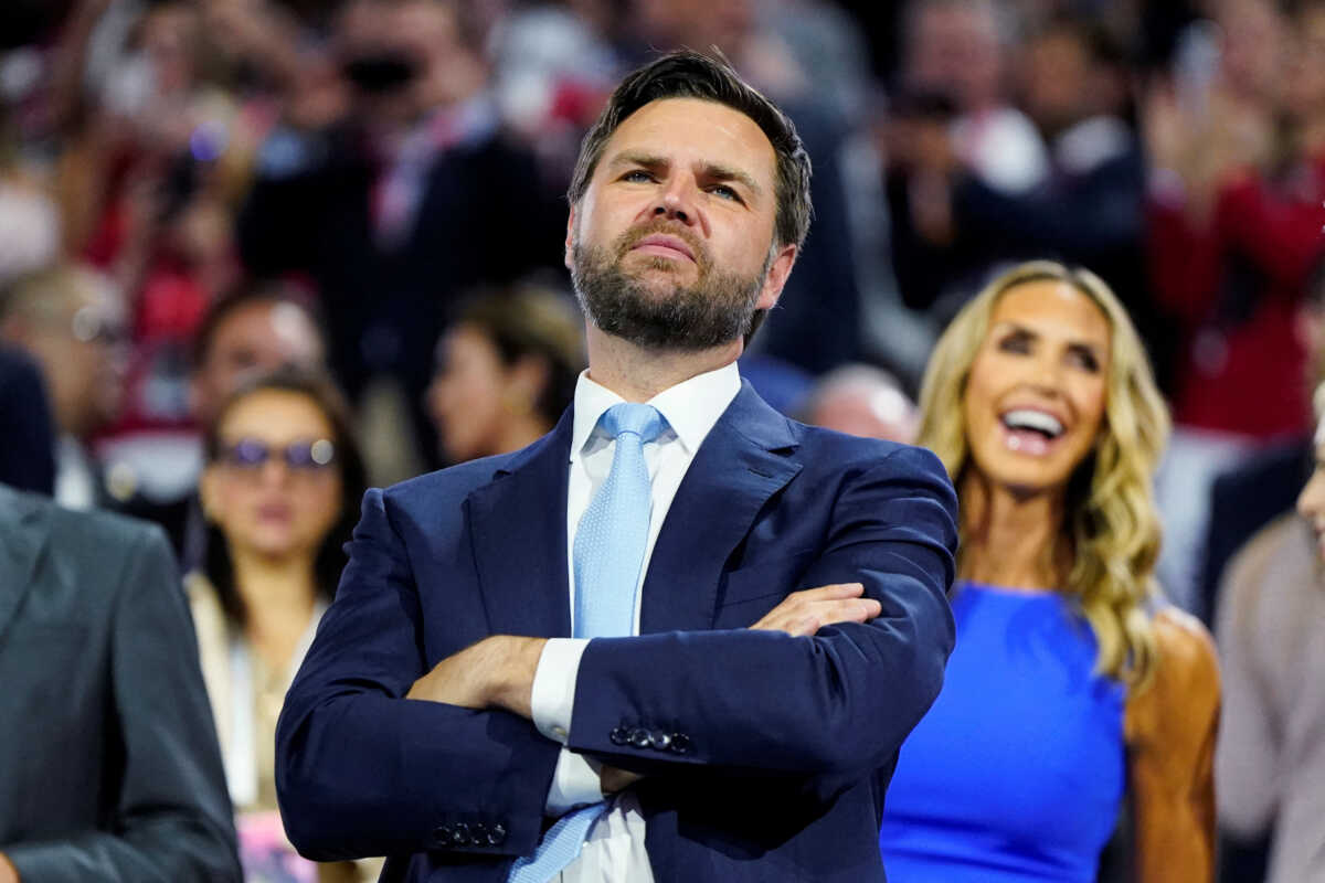 Republican vice presidential nominee J.D. Vance, with RNC co-chair Lara Trump behind him, looks at the stage during Day 1 of the Republican National Convention (RNC), at the Fiserv Forum in Milwaukee, Wisconsin, U.S., July 15, 2024. REUTERS