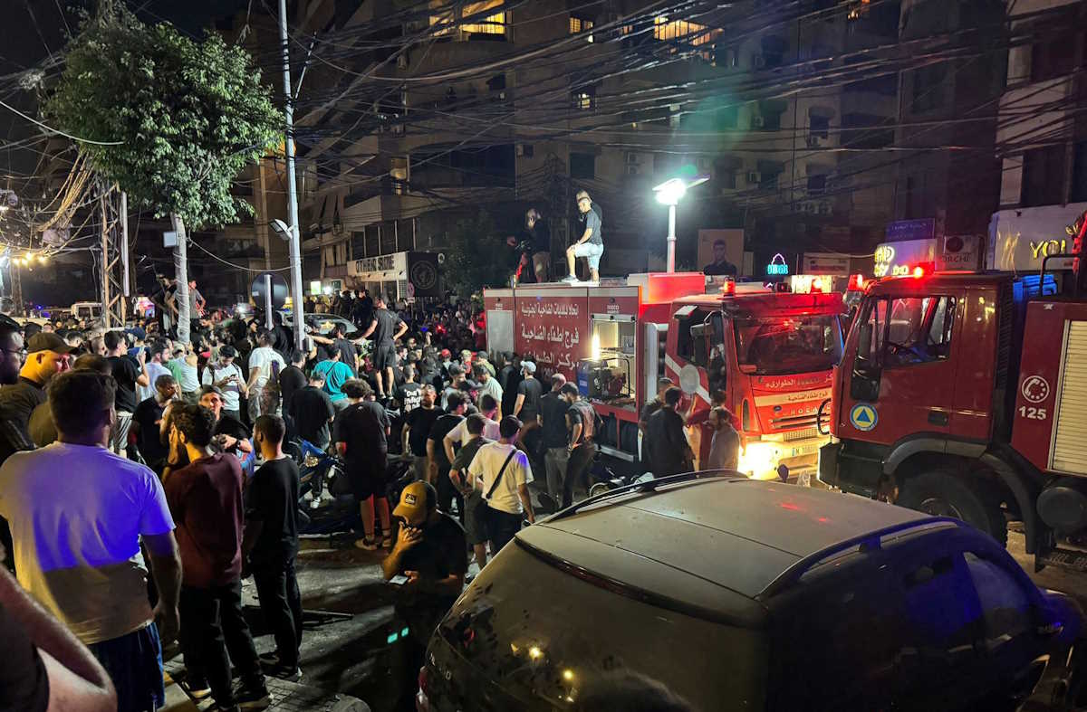 People gather near a site hit by what security sources said was a strike on Beirut's southern suburbs, Lebanon July 30, 2024. REUTERS