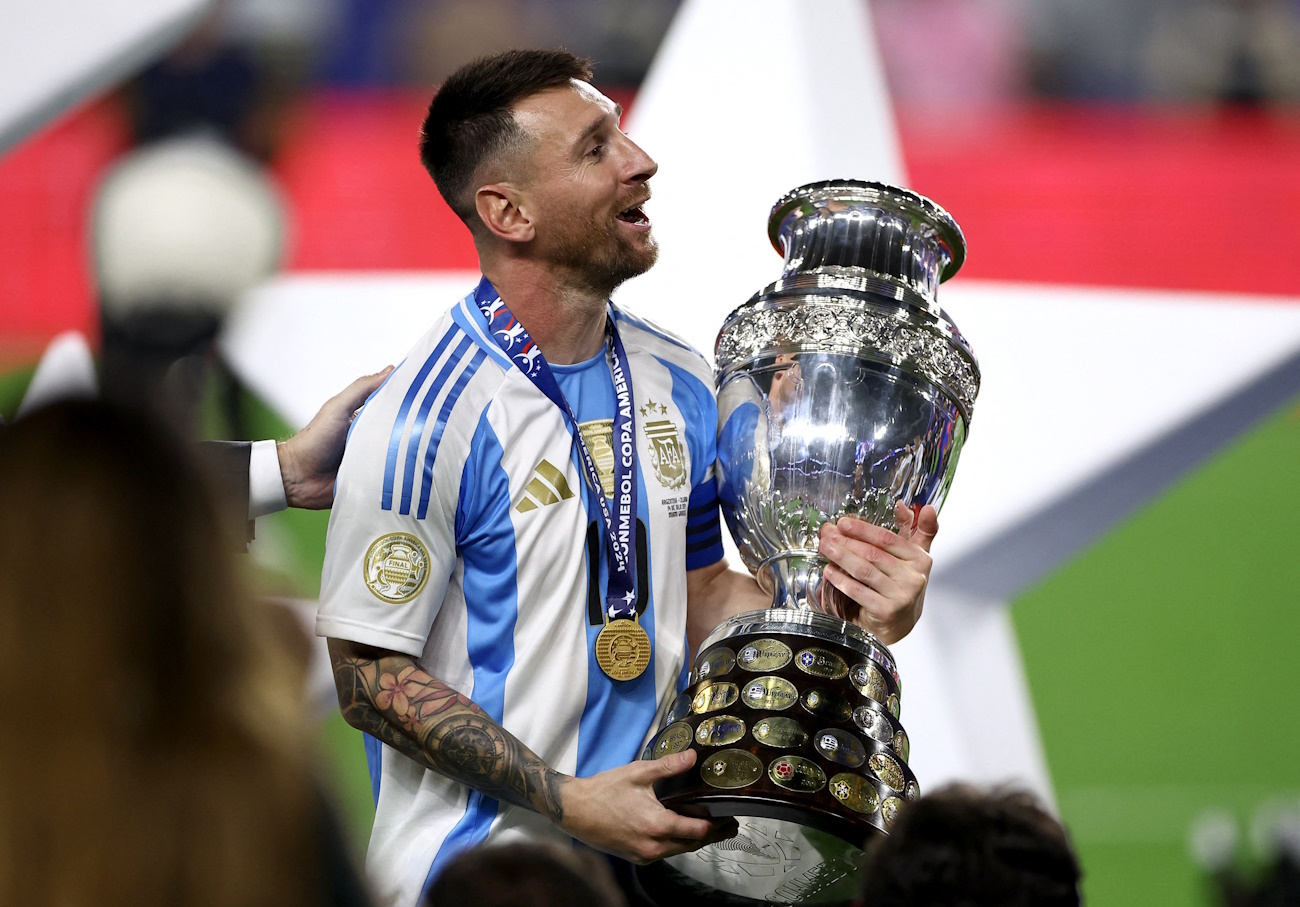 Soccer Football - Copa America 2024 - Final - Argentina v Colombia - Hard Rock Stadium, Miami, Florida, United States - July 15, 2024 Argentina's Lionel Messi celebrates with the trophy after winning Copa America 2024 REUTERS