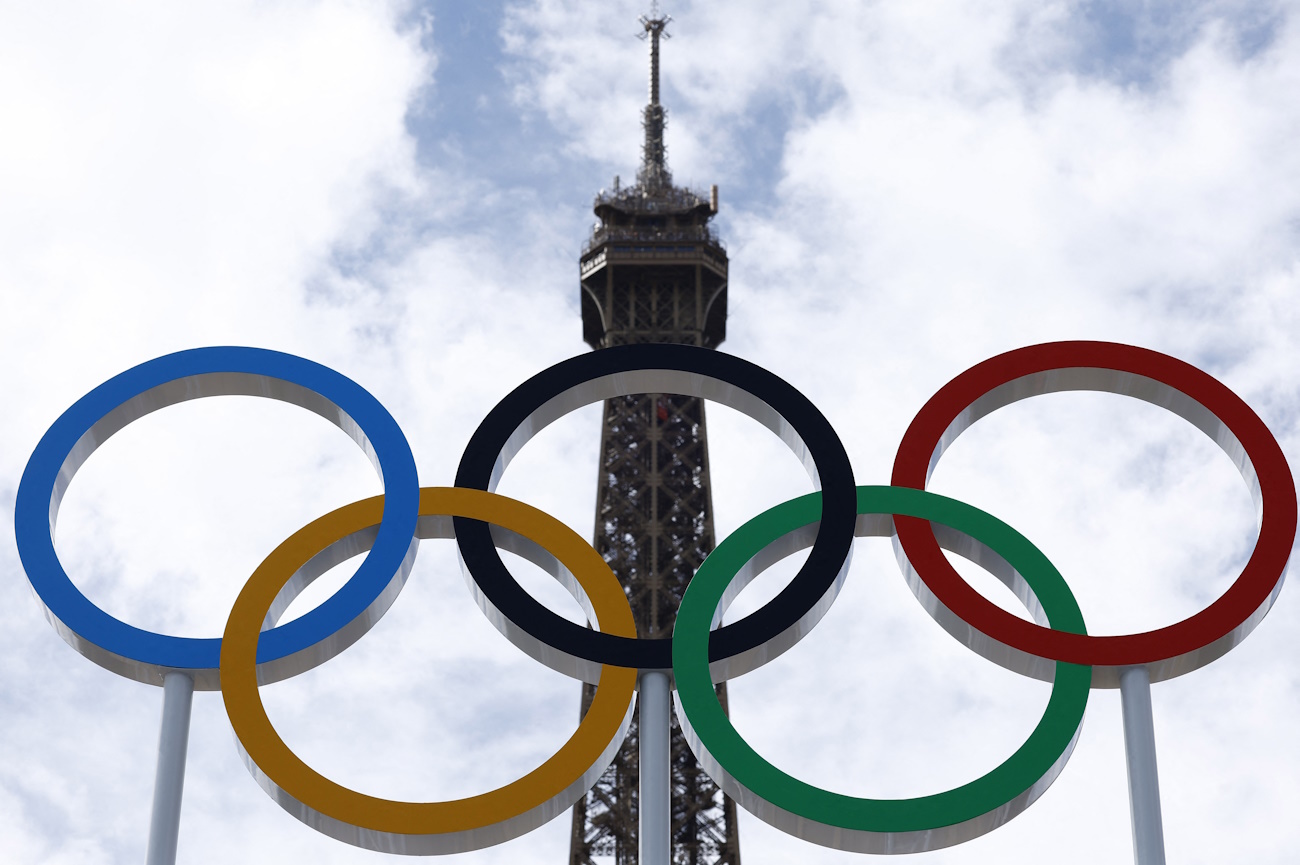 Paris 2024 Olympics - Olympics volleyball venue filled with sand at the base of the Eiffel Tower - Paris, France - July 10, 2024 The Olympic rings are seen on Eiffel Tower Stadium, the venue for beach volleyball at the Olympics REUTERS