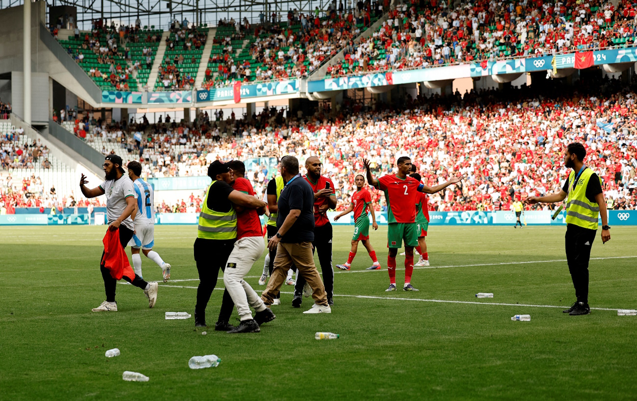 FILE PHOTO: Paris 2024 Olympics - Football - Men's Group B - Argentina vs Morocco - Geoffroy-Guichard Stadium, Saint-Etienne, France - July 24, 2024. Achraf Hakimi of Morocco reacts as pitch invaders run to the pitch after the match. REUTERS