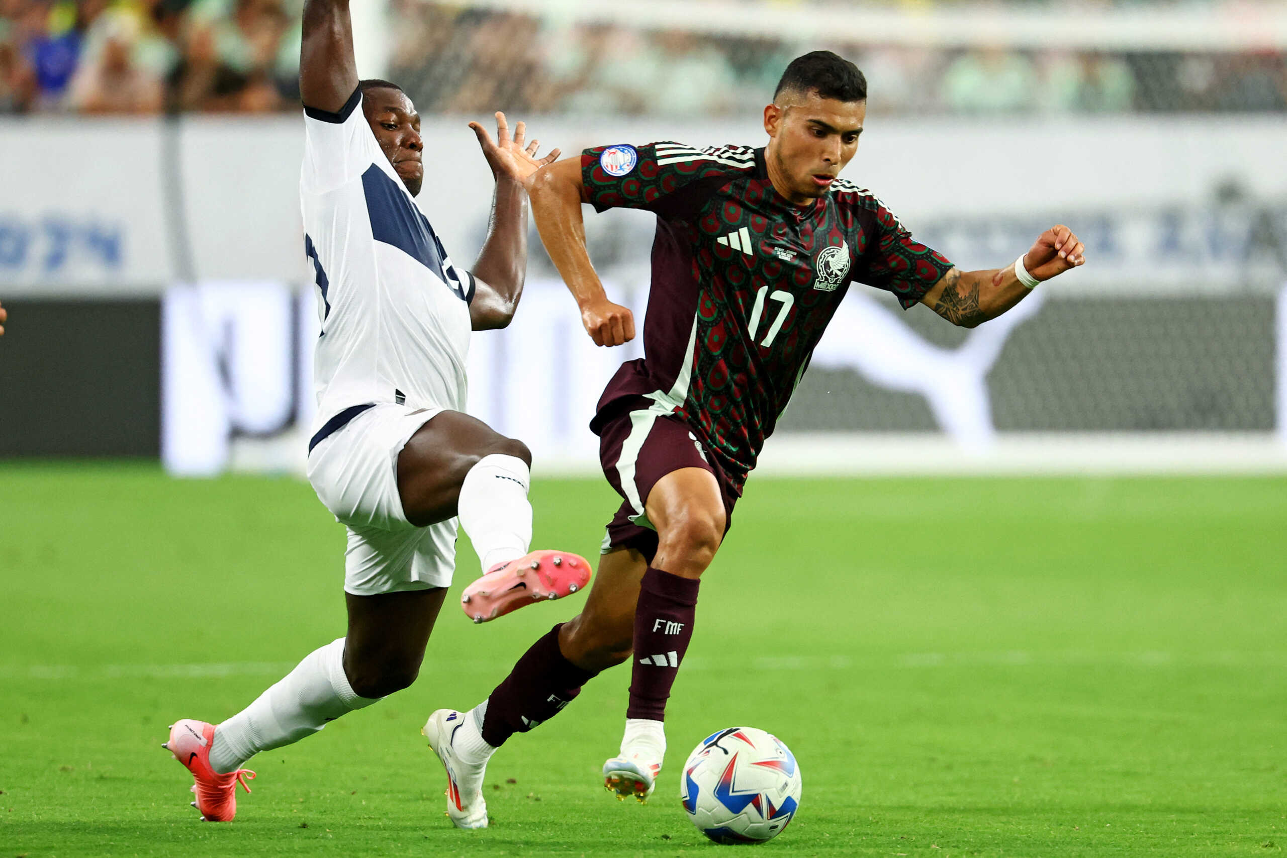 Jun 30, 2024; Glendale, AZ, USA; Mexico midfielder Orbelin Pineda (17) controls the ball against Ecuador midfielder Moises Caicedo (23) during the first half] in the Copa America soccer tournament at State Farm Stadium. Mandatory Credit: Mark J. Rebilas-USA TODAY Sports