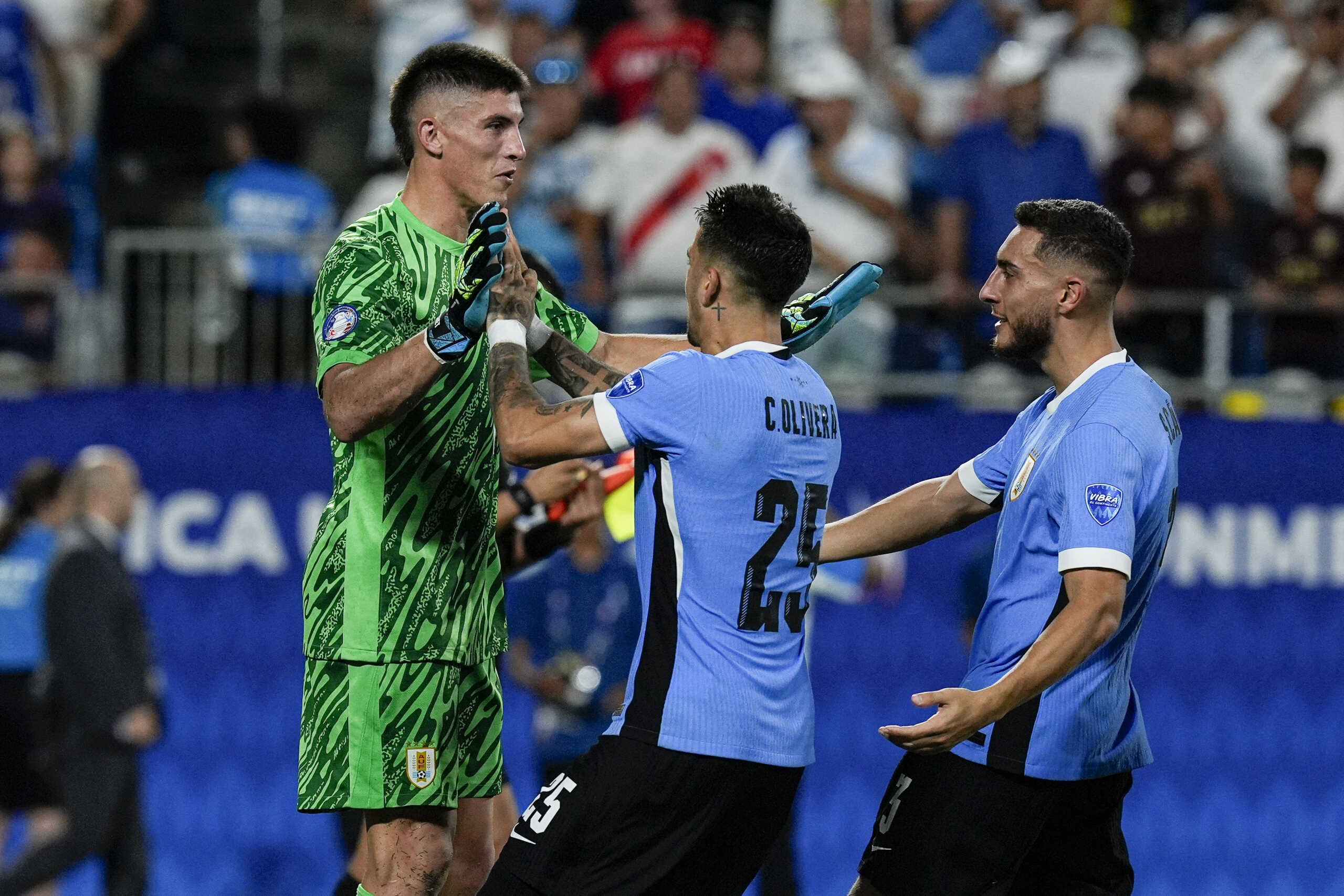 Jul 13, 2024; Charlotte, NC, USA; Uruguay goalkeeper Sergio Rochet (1) high fives teammates after successfully winning the penalty kick contest against Canada during the second half at Bank of America Stadium. Mandatory Credit: Jim Dedmon-USA TODAY Sports