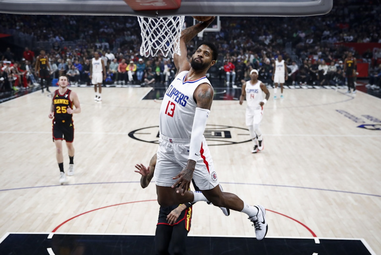 epa11227399 Los Angeles Clippers forward Paul George drives to the basket during the first half of the NBA basketball game between the Atlanta Hawks and the Los Angeles Clippers at Crypto.com Arena in Los Angeles, California, USA, 17 March 2024.  EPA