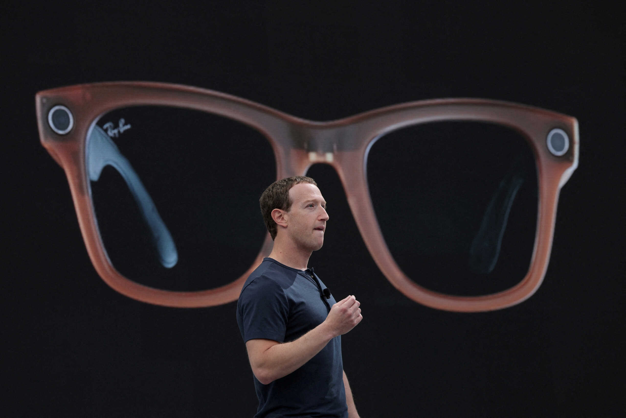 FILE PHOTO: Meta CEO Mark Zuckerberg delivers a speech, as a pair of Ray-Ban smart glasses appear on screen, during the Meta Connect event at the company's headquarters in Menlo Park, California, U.S., September 27, 2023. REUTERS