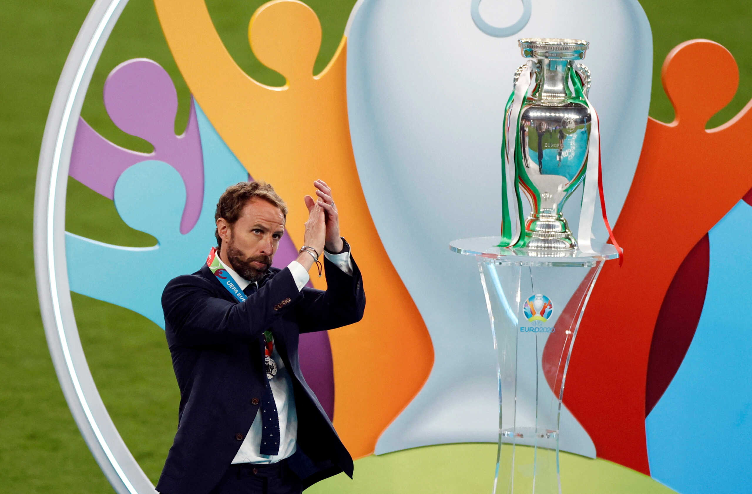 FILE PHOTO: Soccer Football - Euro 2020 - Final - Italy v England - Wembley Stadium, London, Britain - July 11, 2021 England manager Gareth Southgate applauds fans after the match next to the trophy Pool via REUTERS