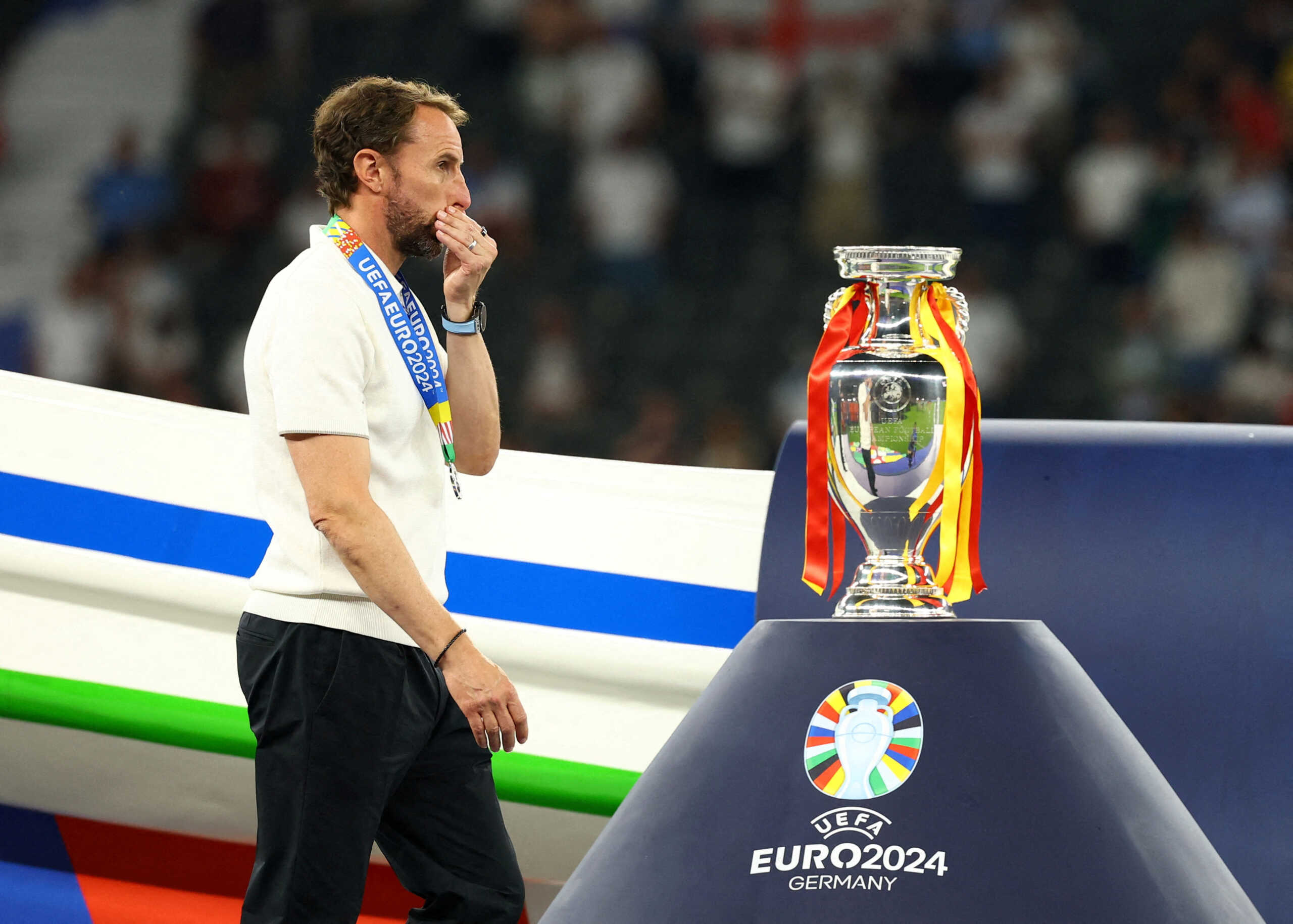 Soccer Football - Euro 2024 - Final - Spain v England - Berlin Olympiastadion, Berlin, Germany - July 14, 2024 England manager Gareth Southgate looks dejected as he walks past the trophy after receiving his runners up medal REUTERS
