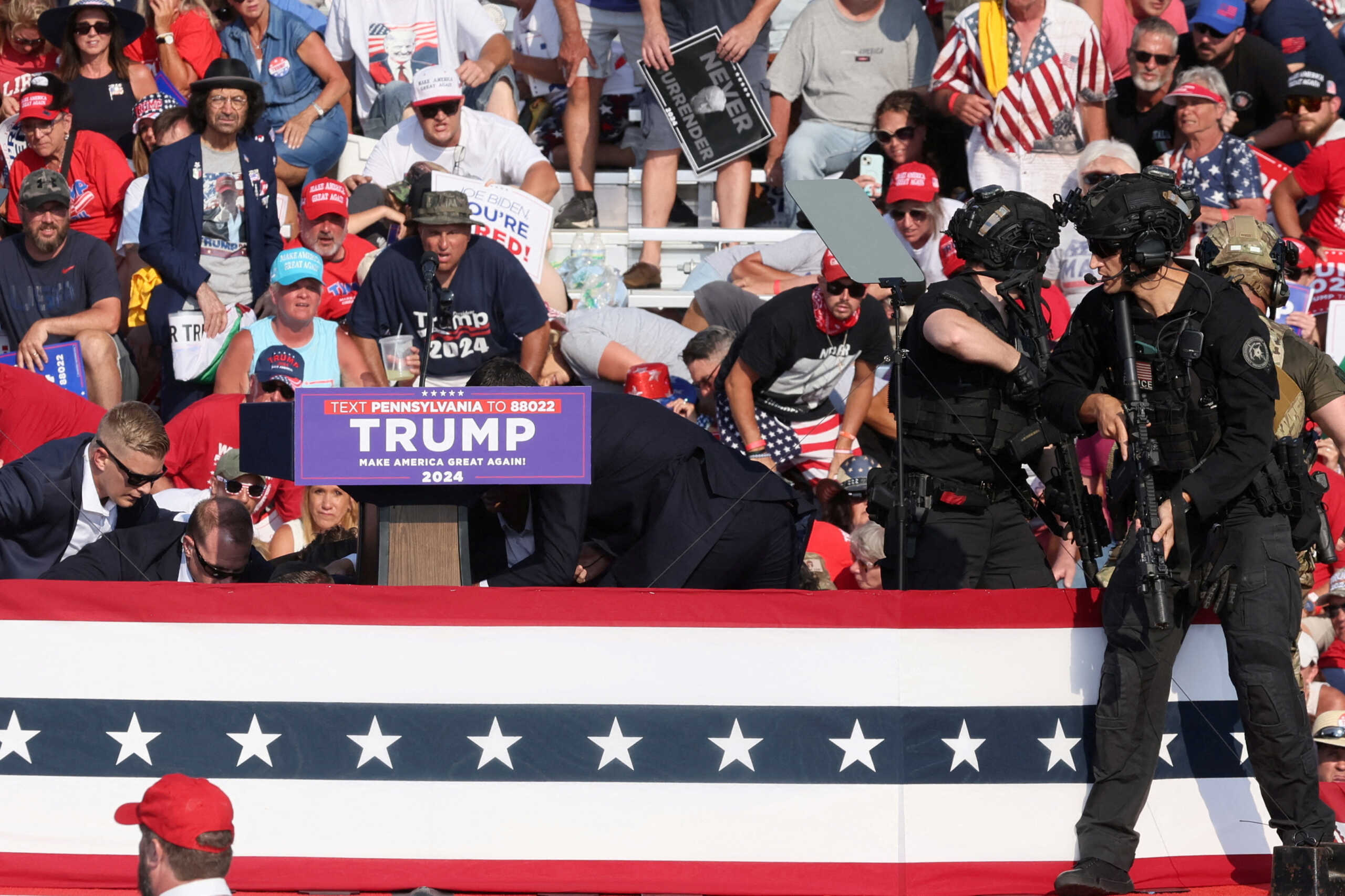 Republican presidential candidate and former U.S. President Donald Trump is assisted by U.S. Secret Service personnel after gunfire rang out during a campaign rally at the Butler Farm Show in Butler, Pennsylvania, U.S., July 13, 2024. REUTERS