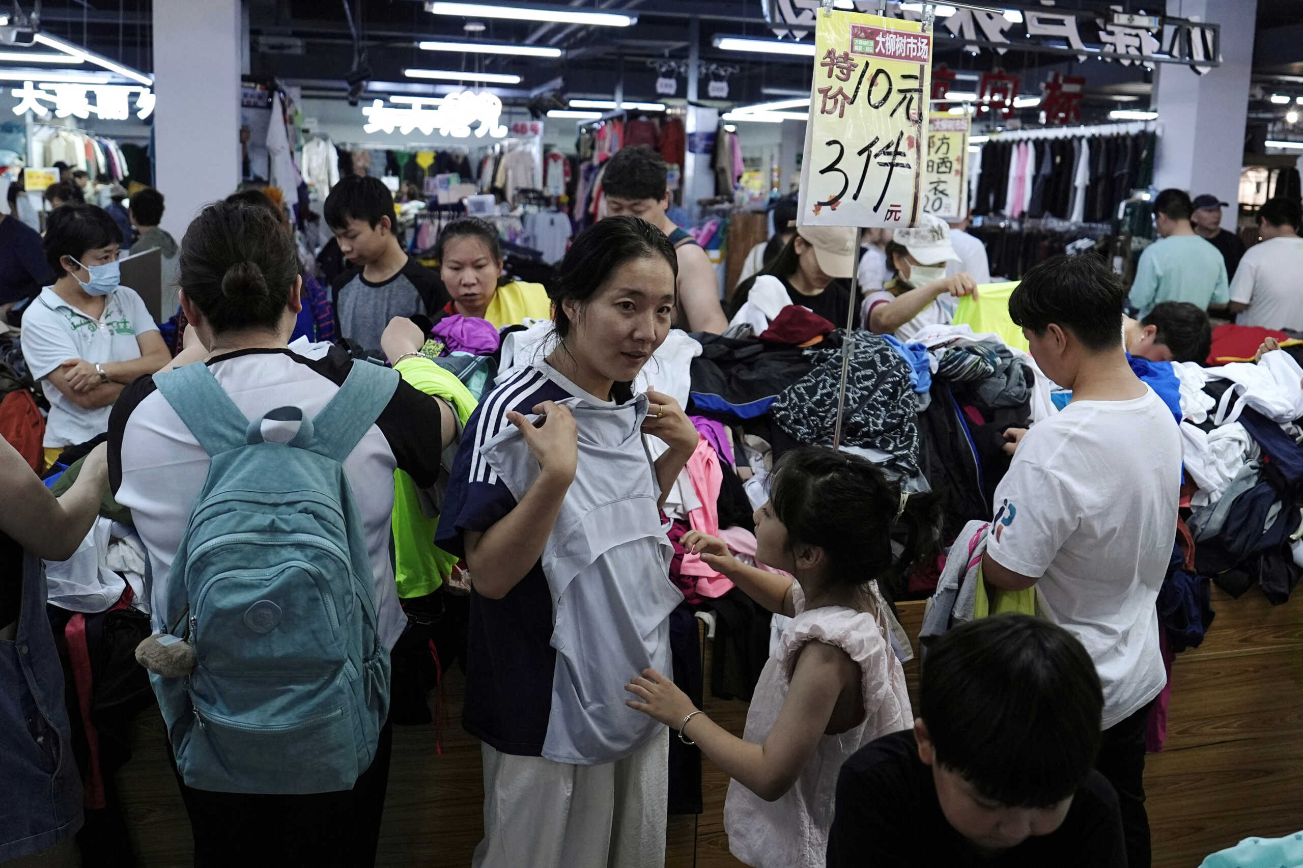 Customers shop at a discount clothing shop in Beijing, China July 14, 2024. REUTERS