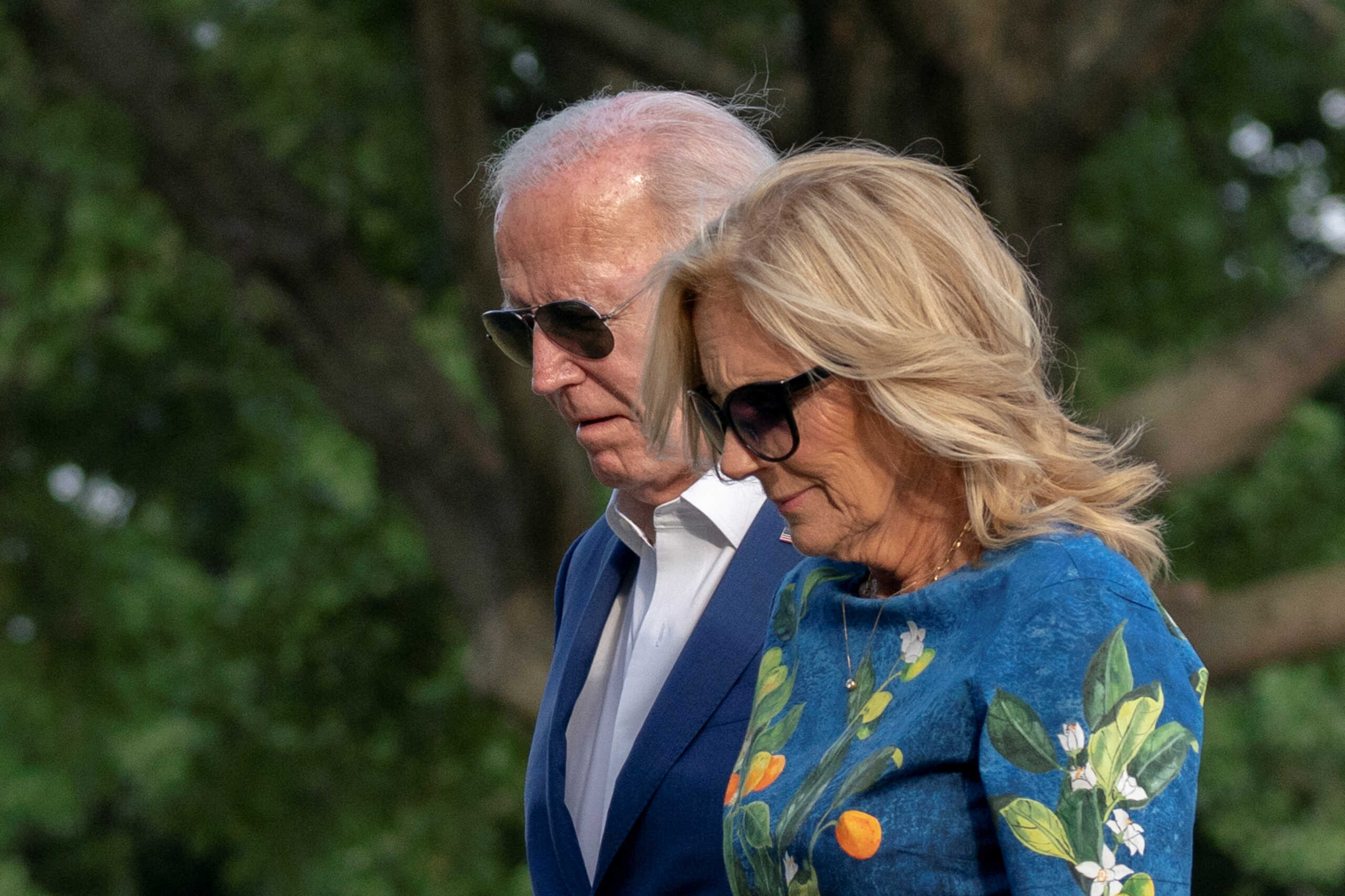 U.S. President Joe Biden and first lady Jill Biden walk after stepping off Marine One following their arrival on the South Lawn of the White House in Washington, U.S. July 7, 2024. REUTERS